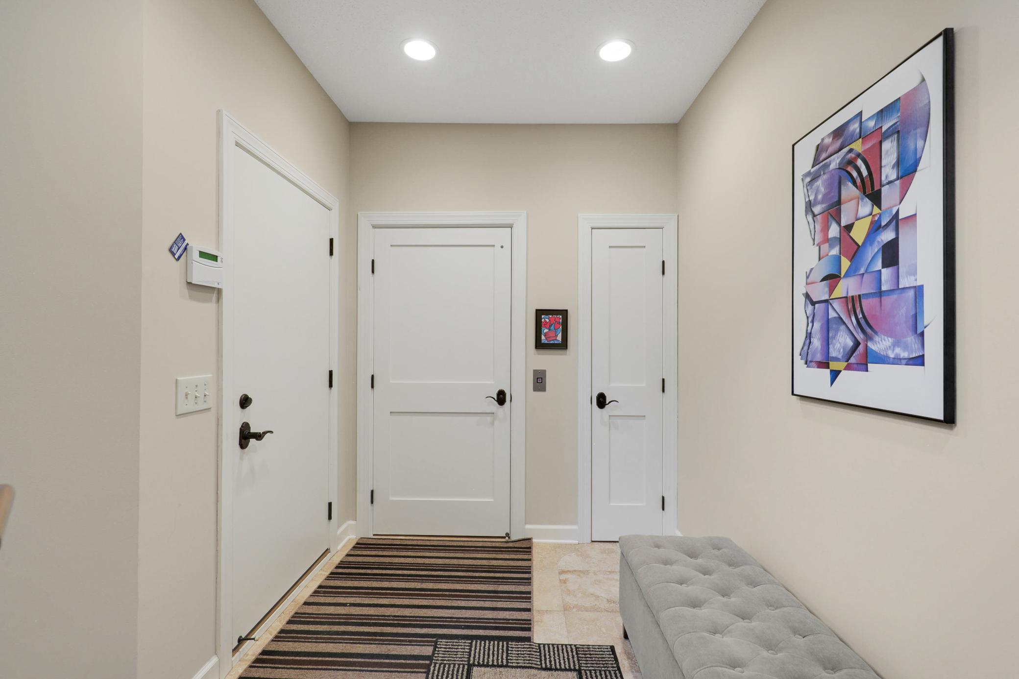 Upscale end unit with main-floor living, a private elevator, walkable to shopping and restaurants