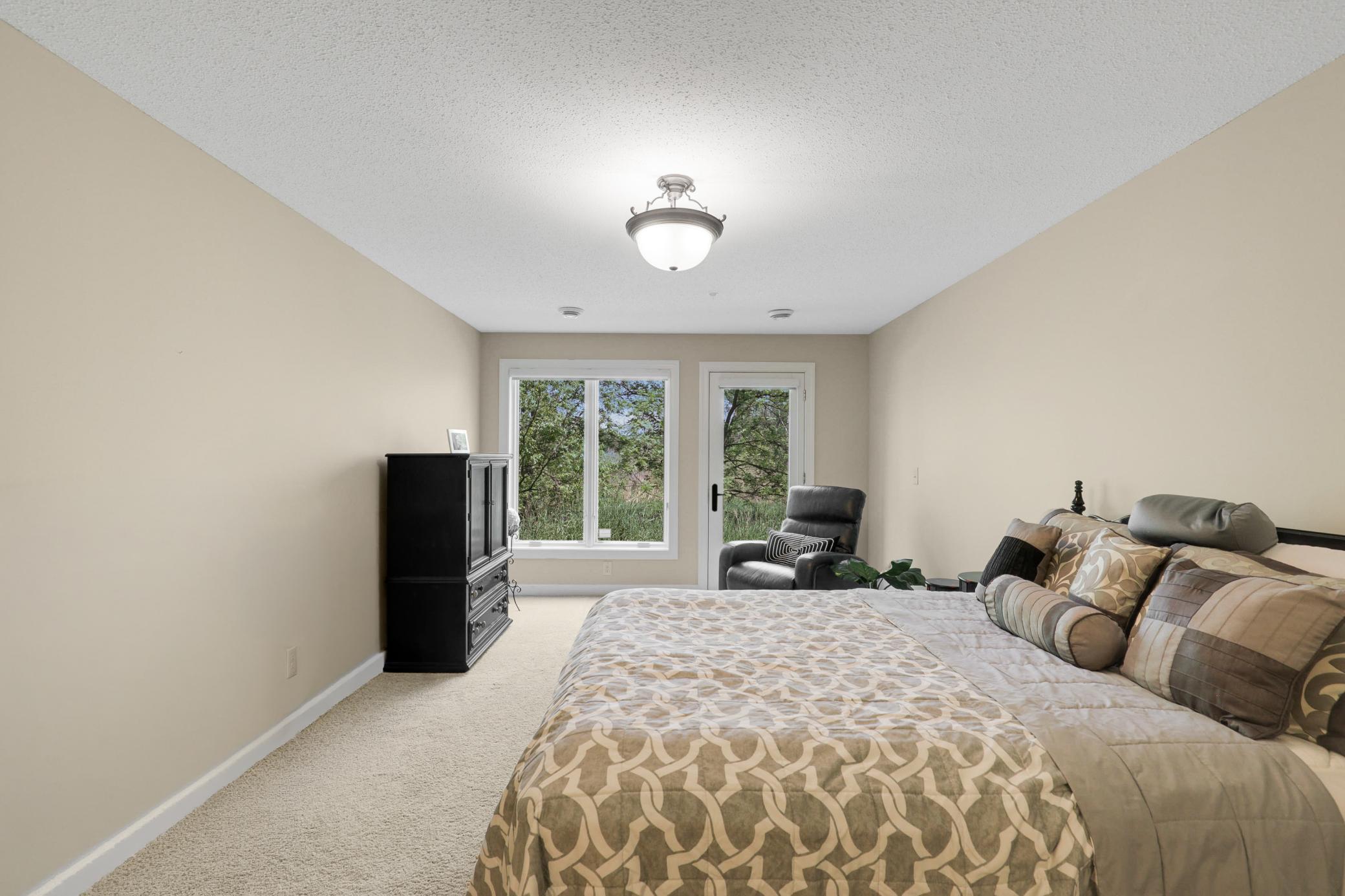 Upscale end unit with main-floor living, a private elevator, walkable to shopping and restaurants