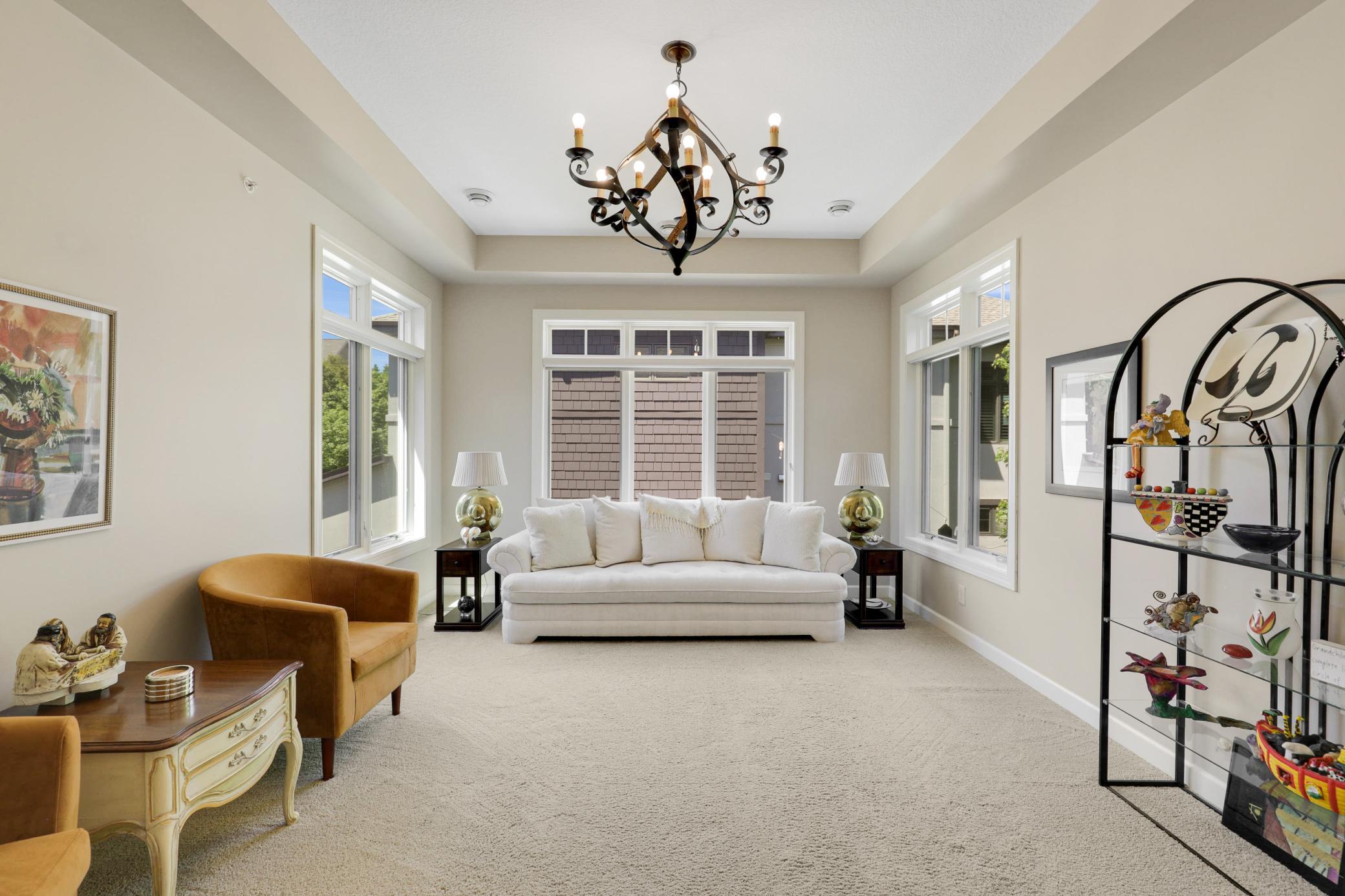 Upscale end unit with main-floor living, a private elevator, walkable to shopping and restaurants