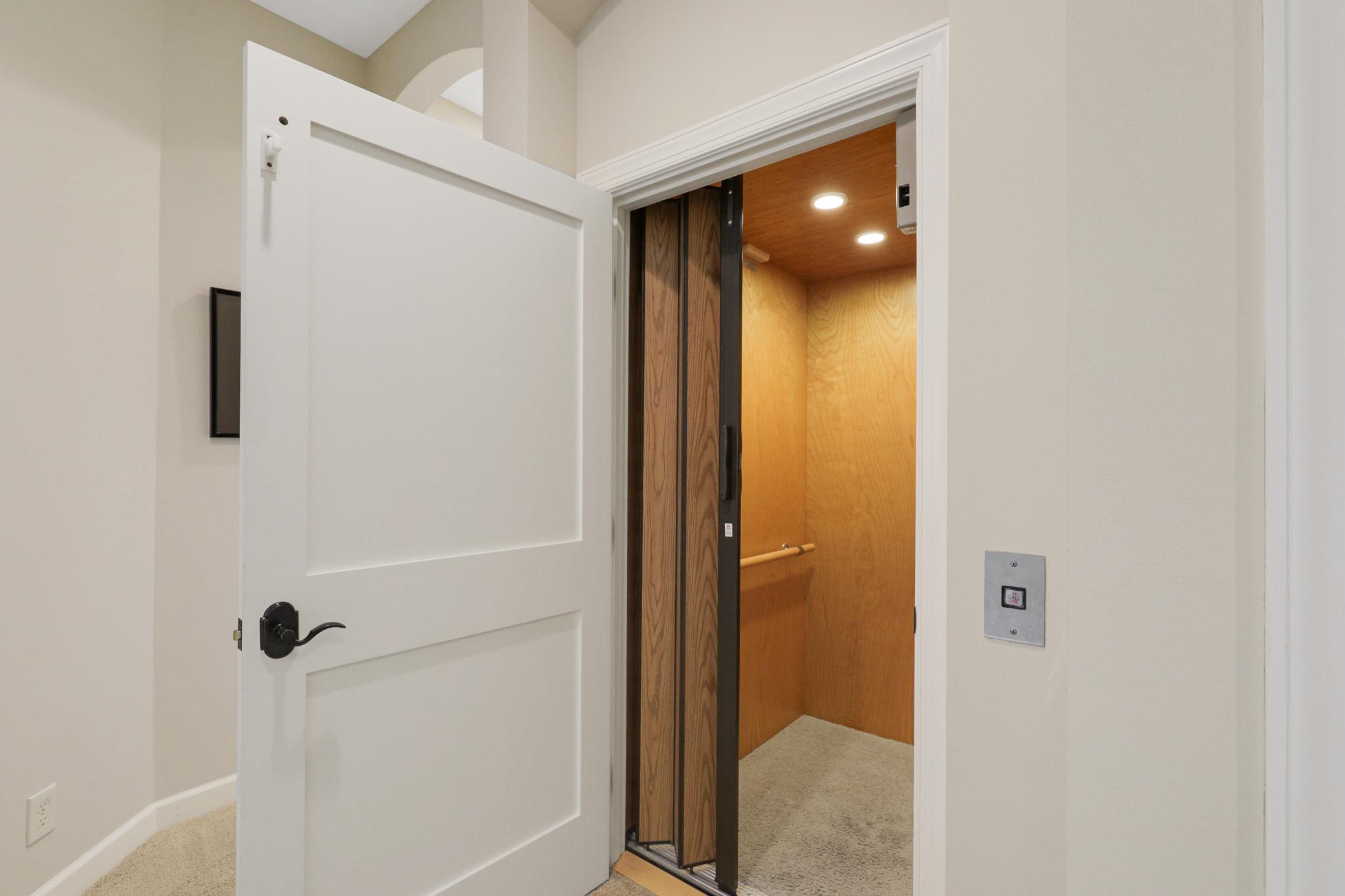Upscale end unit with main-floor living, a private elevator, walkable to shopping and restaurants