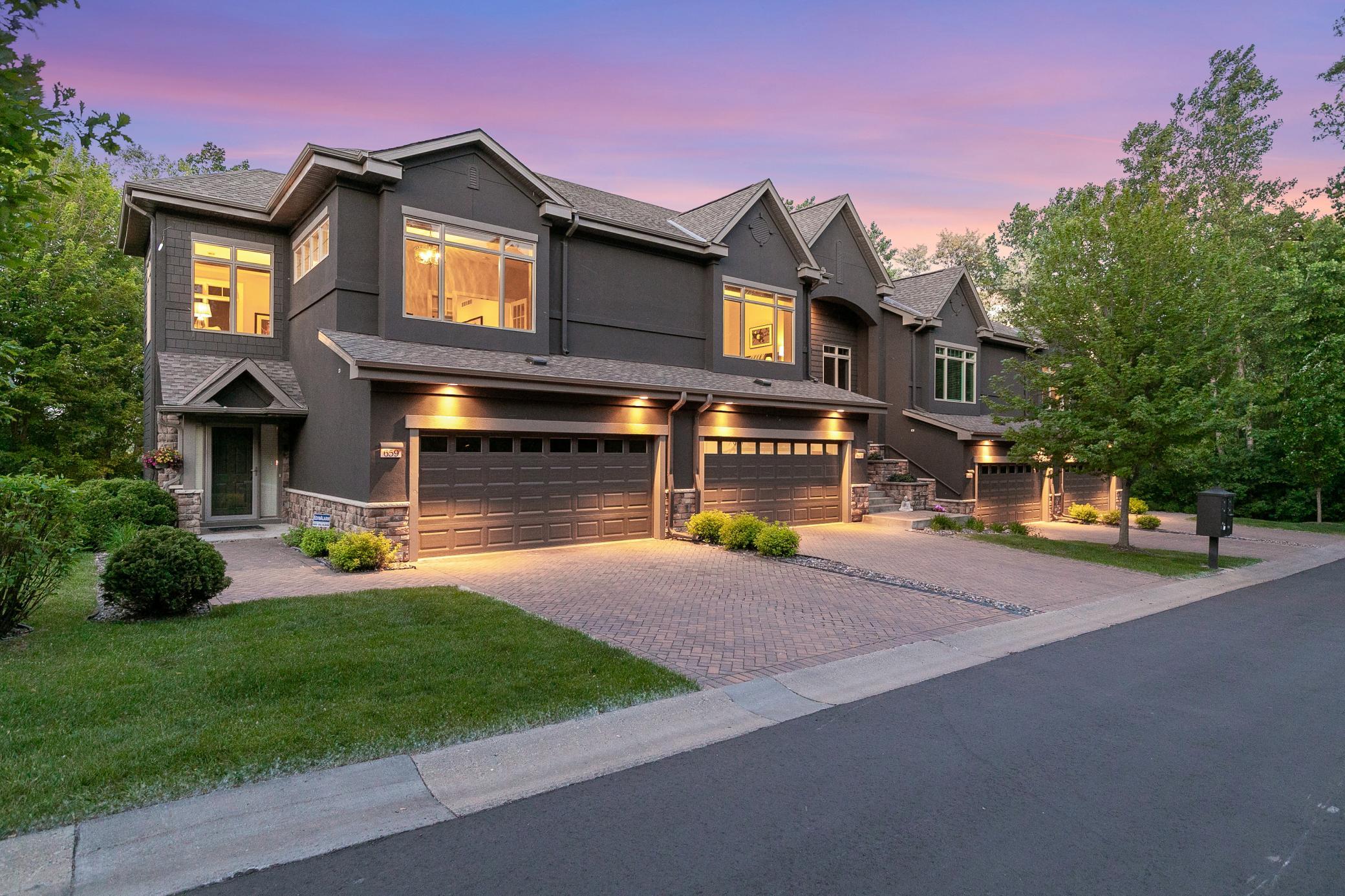 Upscale end unit with main-floor living, a private elevator, walkable to shopping and restaurants