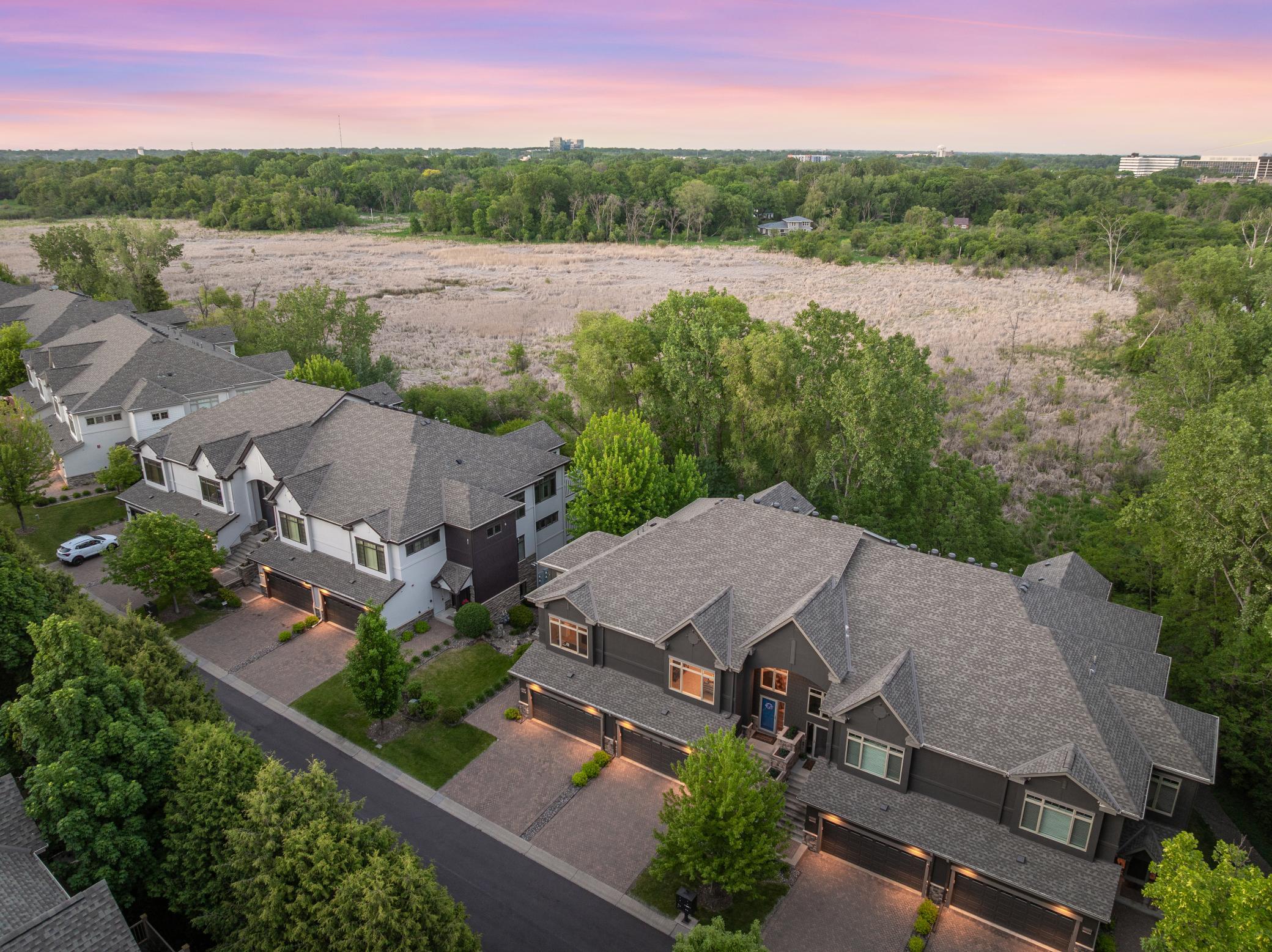 Upscale end unit with main-floor living, a private elevator, walkable to shopping and restaurants