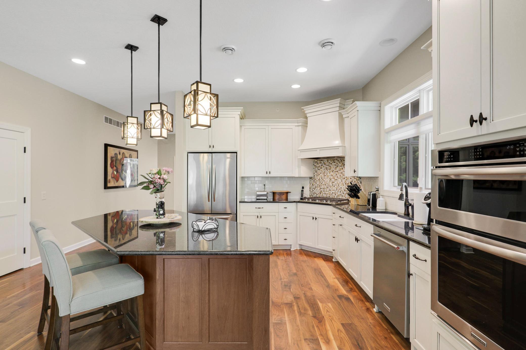 Upscale end unit with main-floor living, a private elevator, walkable to shopping and restaurants