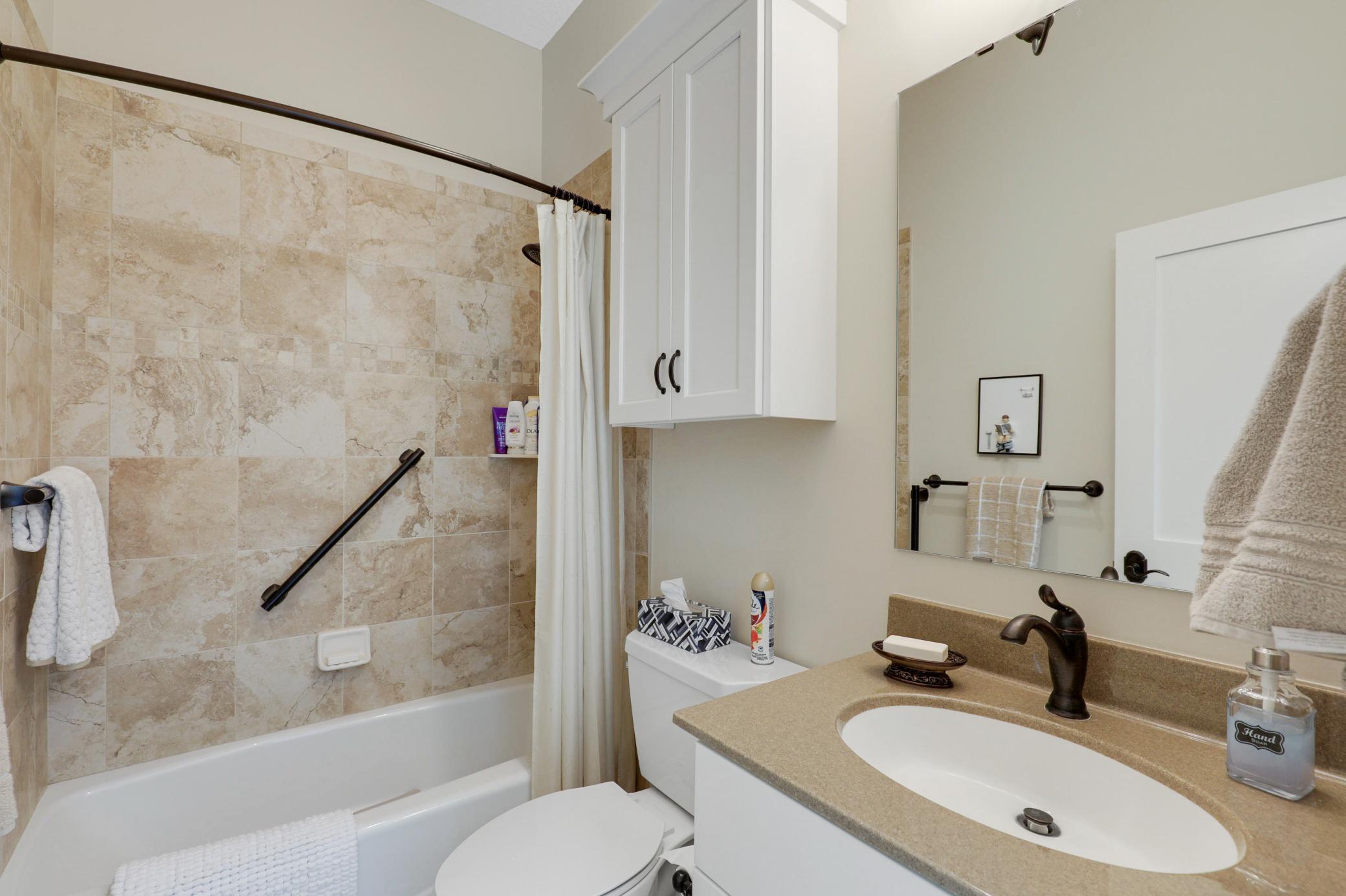 Upscale end unit with main-floor living, a private elevator, walkable to shopping and restaurants