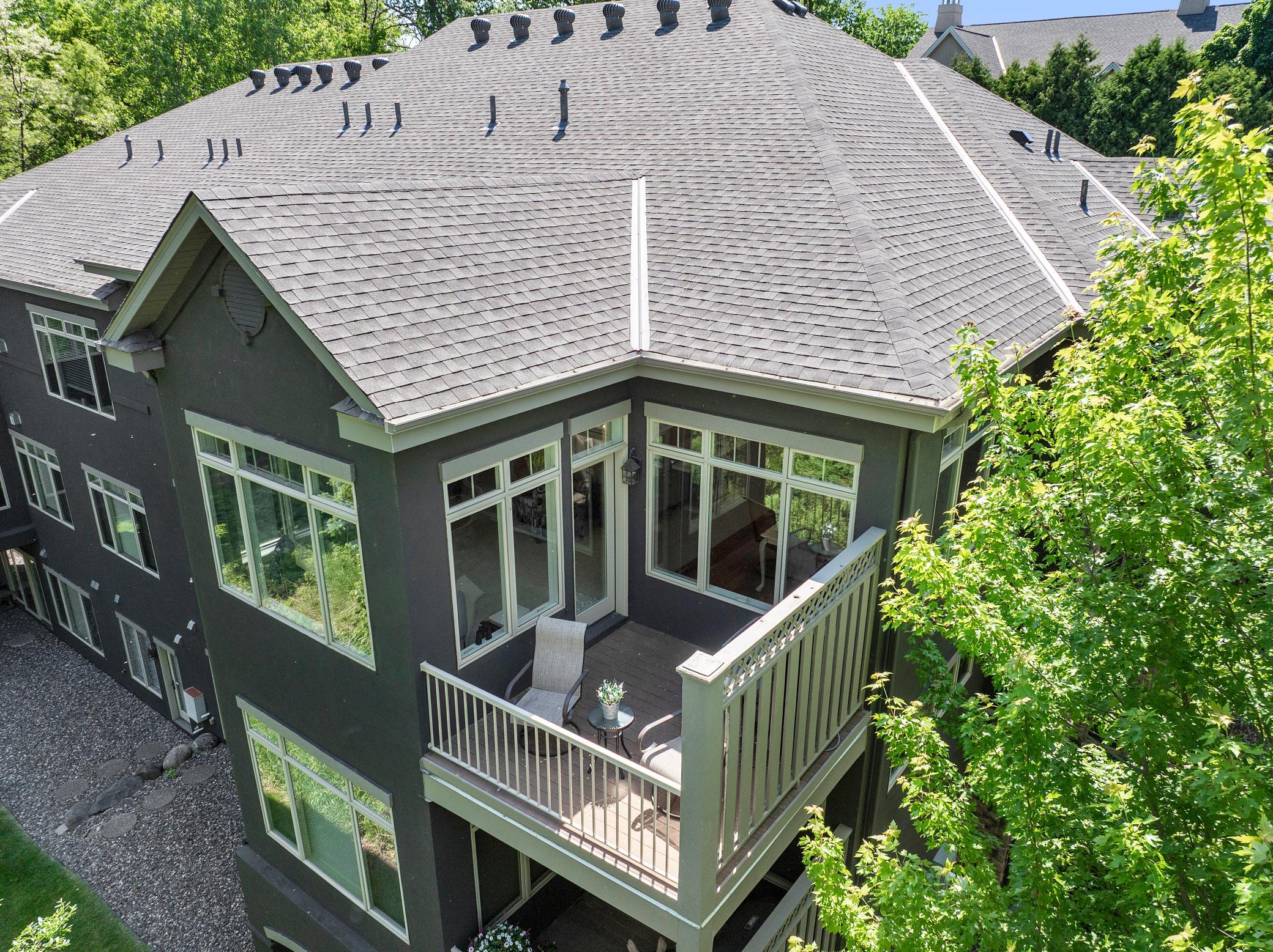 Upscale end unit with main-floor living, a private elevator, walkable to shopping and restaurants