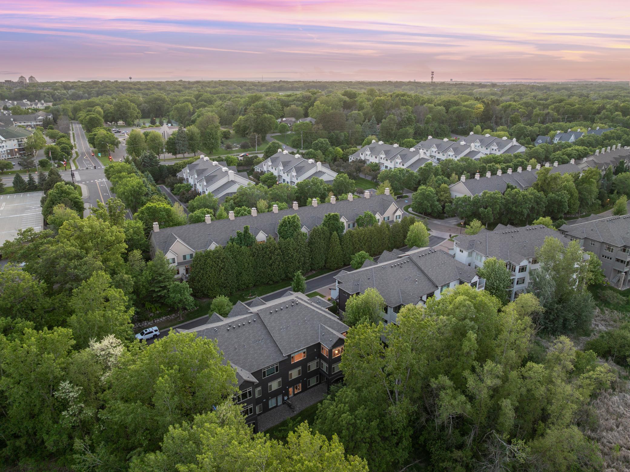 Upscale end unit with main-floor living, a private elevator, walkable to shopping and restaurants