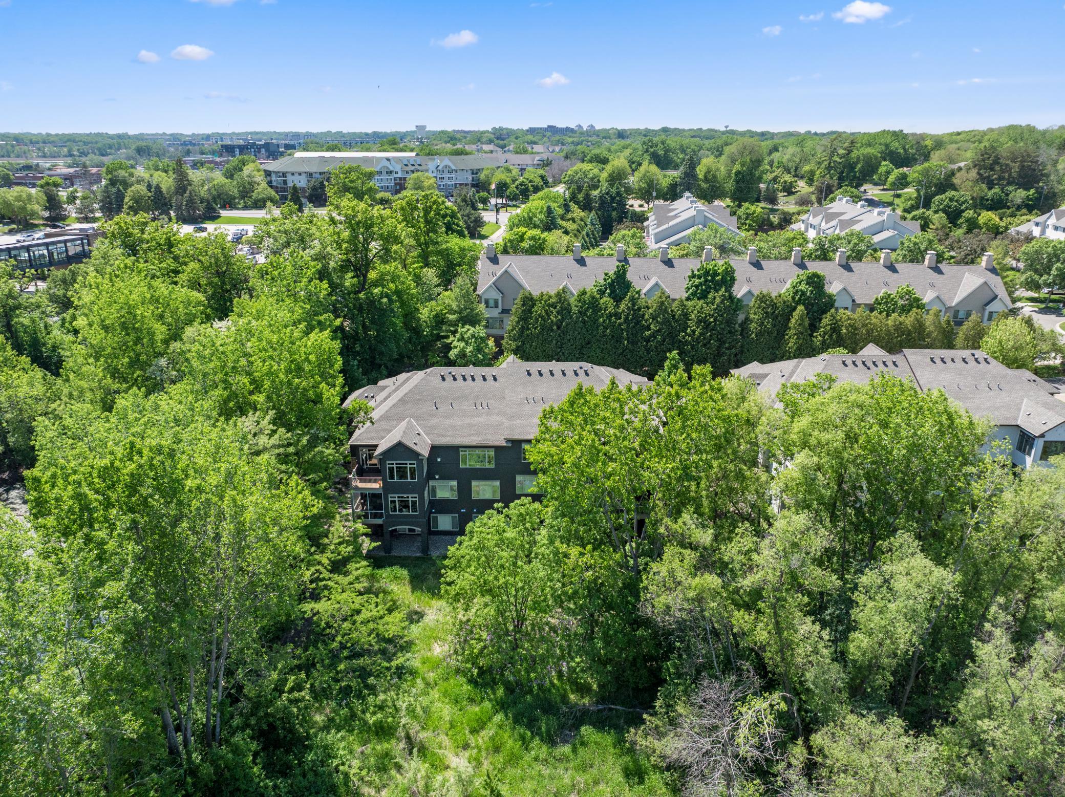 Upscale end unit with main-floor living, a private elevator, walkable to shopping and restaurants