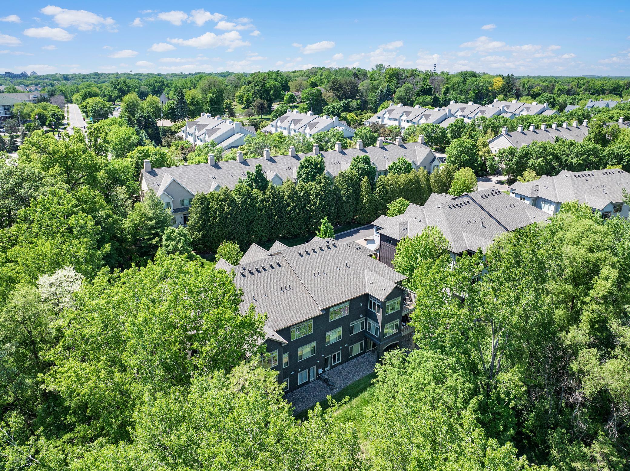 Upscale end unit with main-floor living, a private elevator, walkable to shopping and restaurants