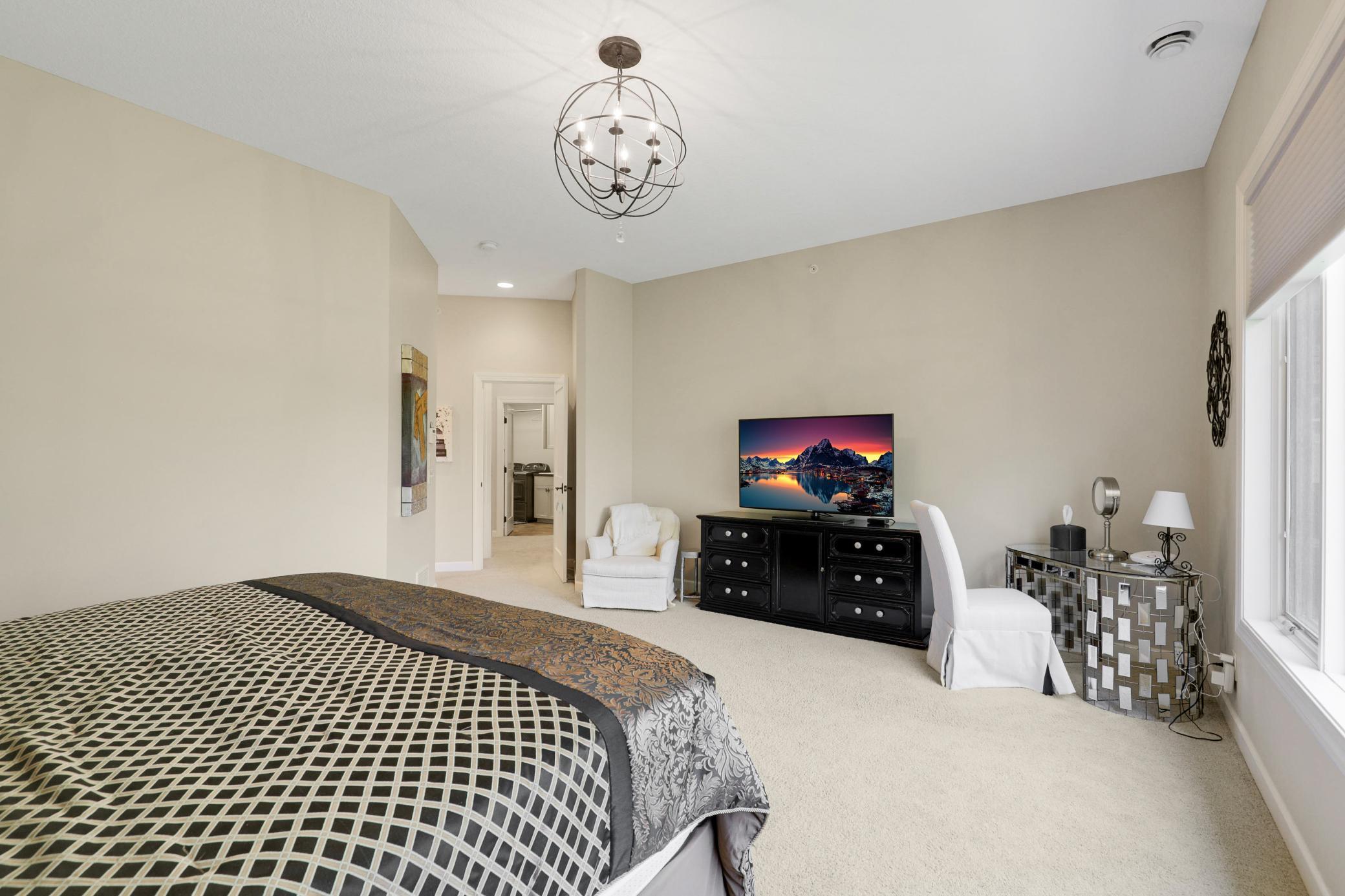 Upscale end unit with main-floor living, a private elevator, walkable to shopping and restaurants