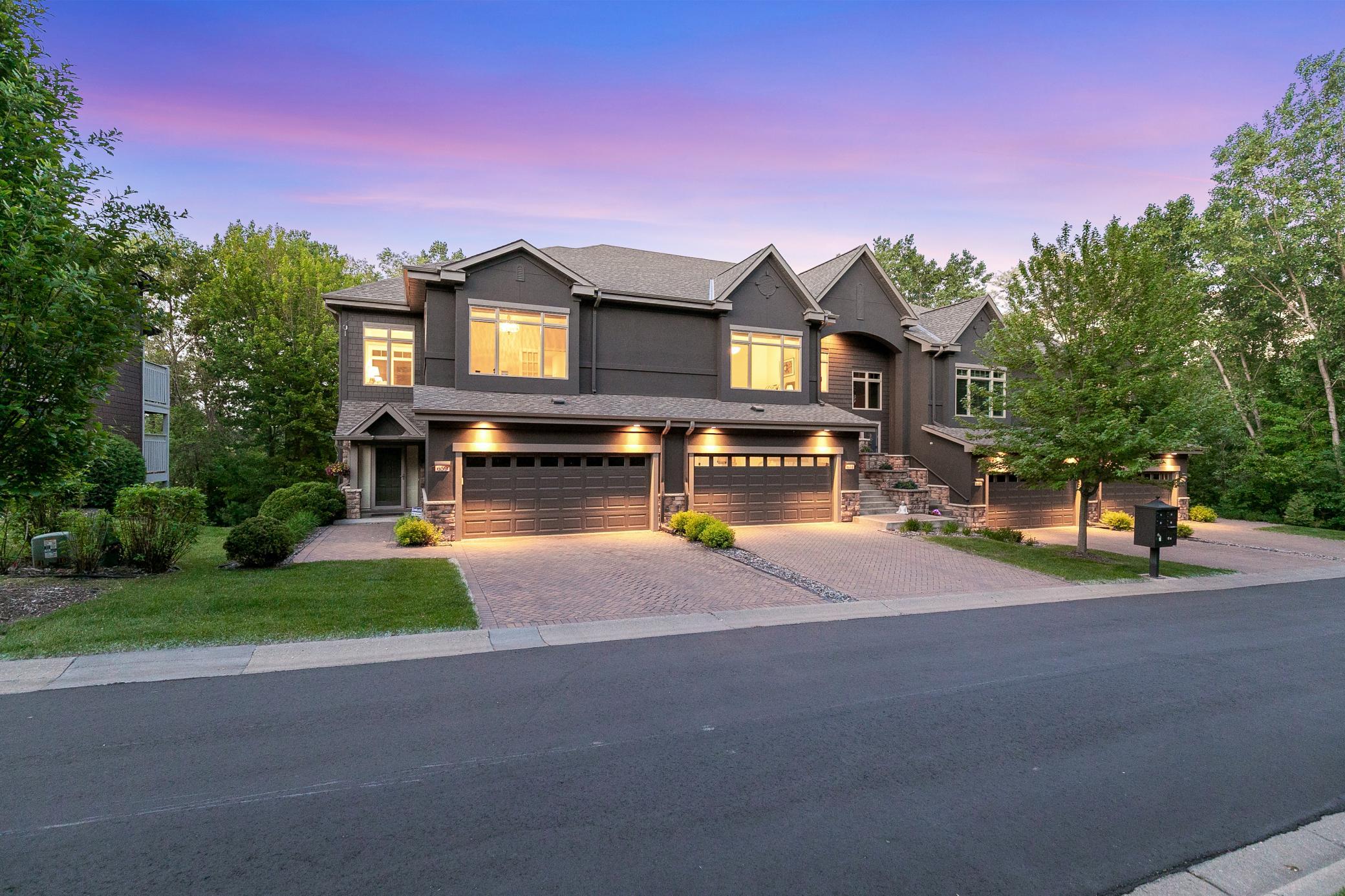 Upscale end unit with main-floor living, a private elevator, walkable to shopping and restaurants