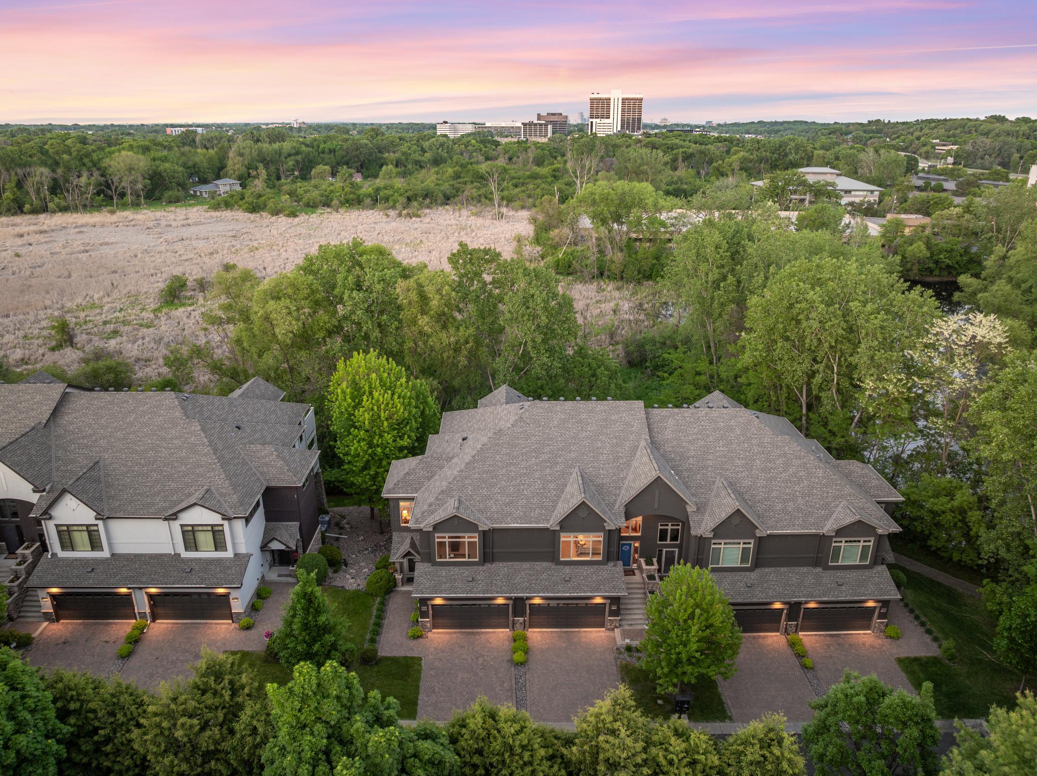 Upscale end unit with main-floor living, a private elevator, walkable to shopping and restaurants