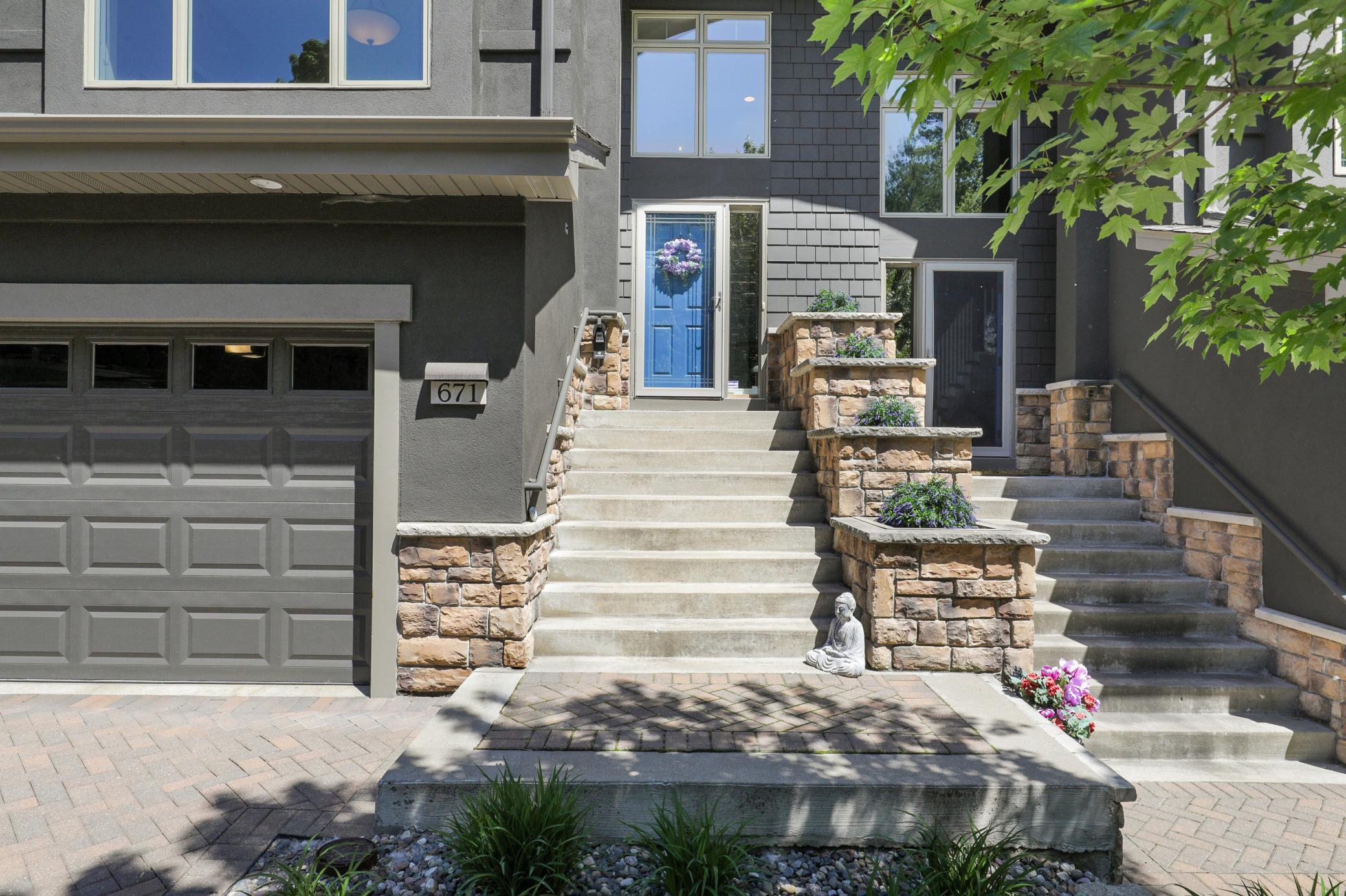 Upscale end unit with main-floor living, a private elevator, walkable to shopping and restaurants