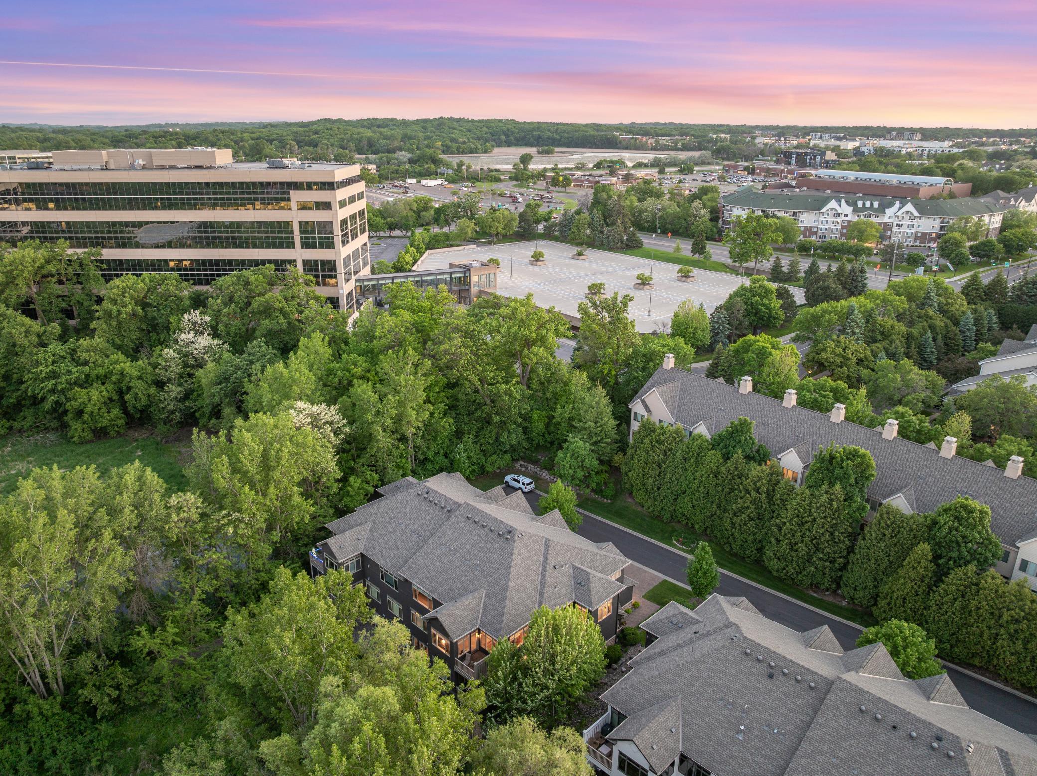 Upscale end unit with main-floor living, a private elevator, walkable to shopping and restaurants