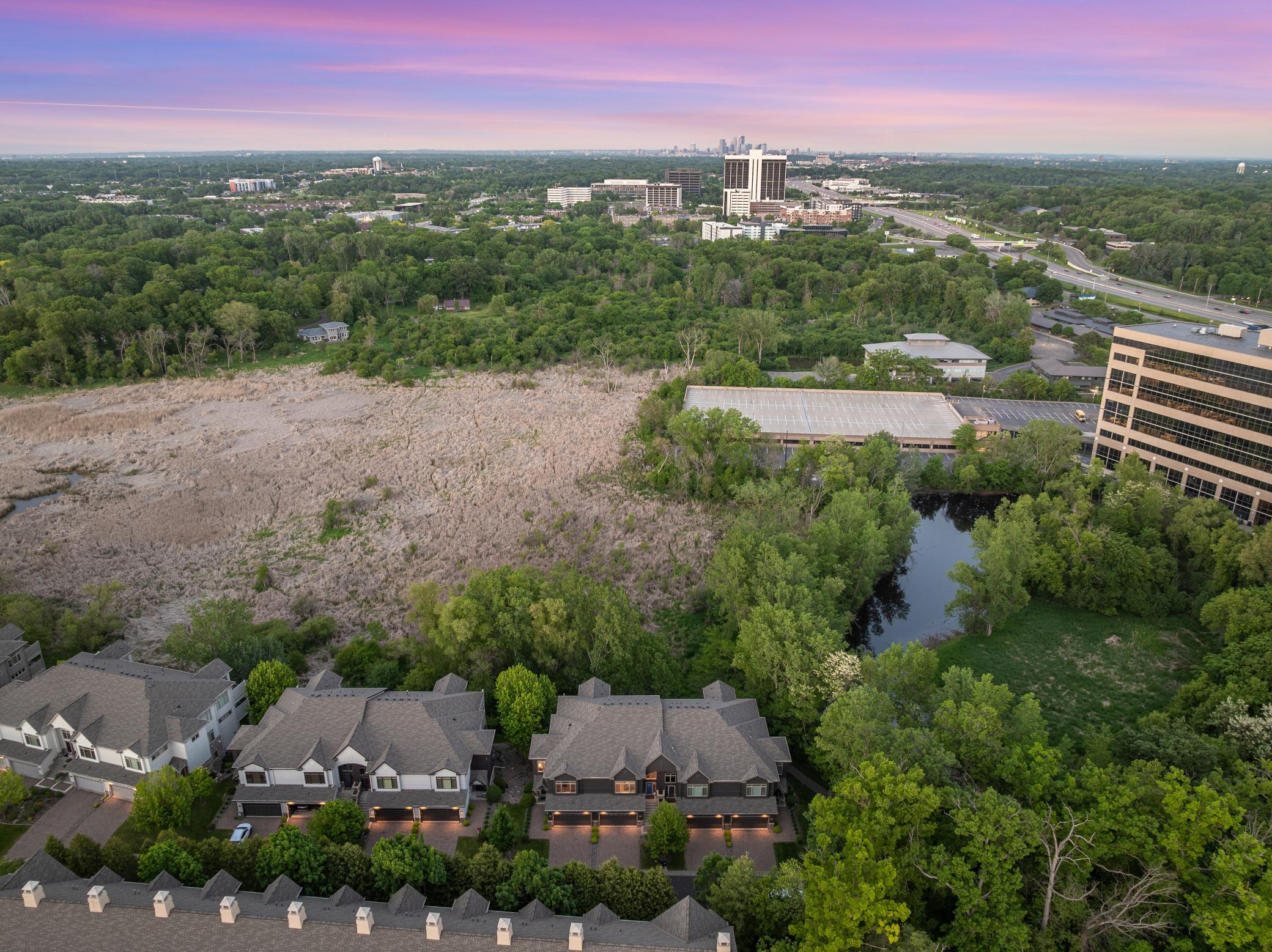 Upscale end unit with main-floor living, a private elevator, walkable to shopping and restaurants