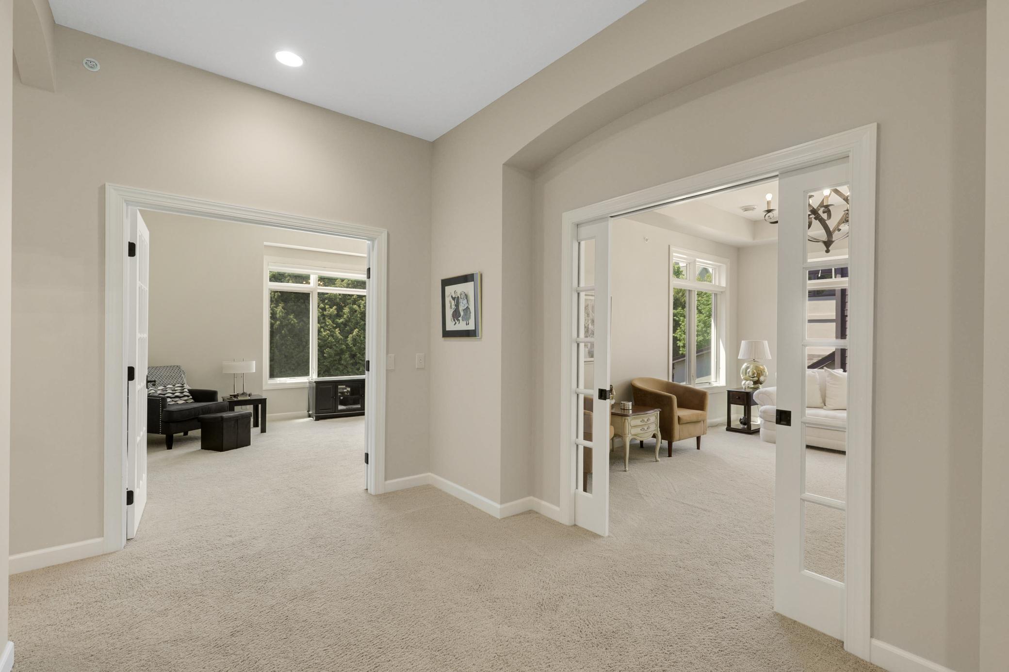 Upscale end unit with main-floor living, a private elevator, walkable to shopping and restaurants