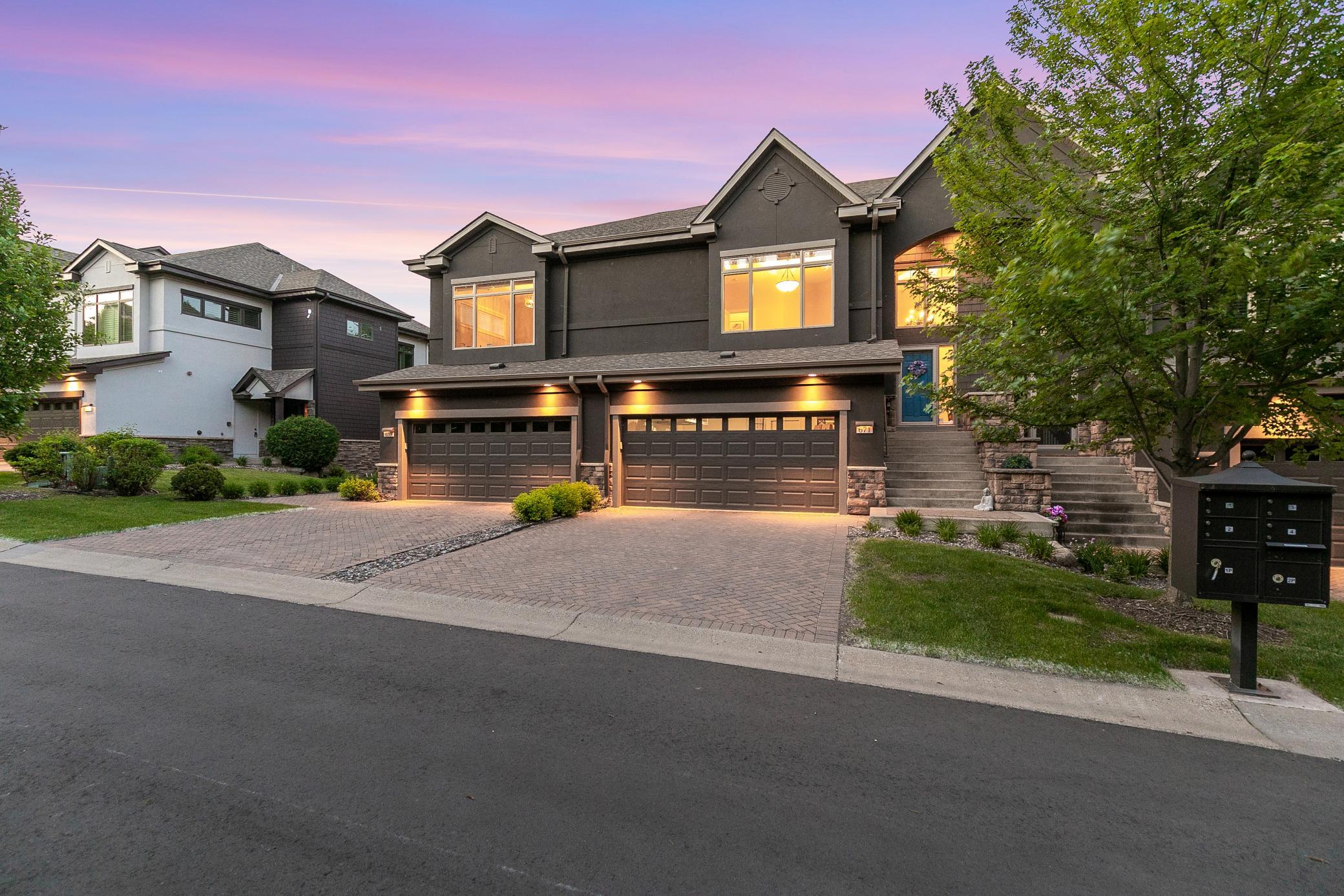 Upscale end unit with main-floor living, a private elevator, walkable to shopping and restaurants
