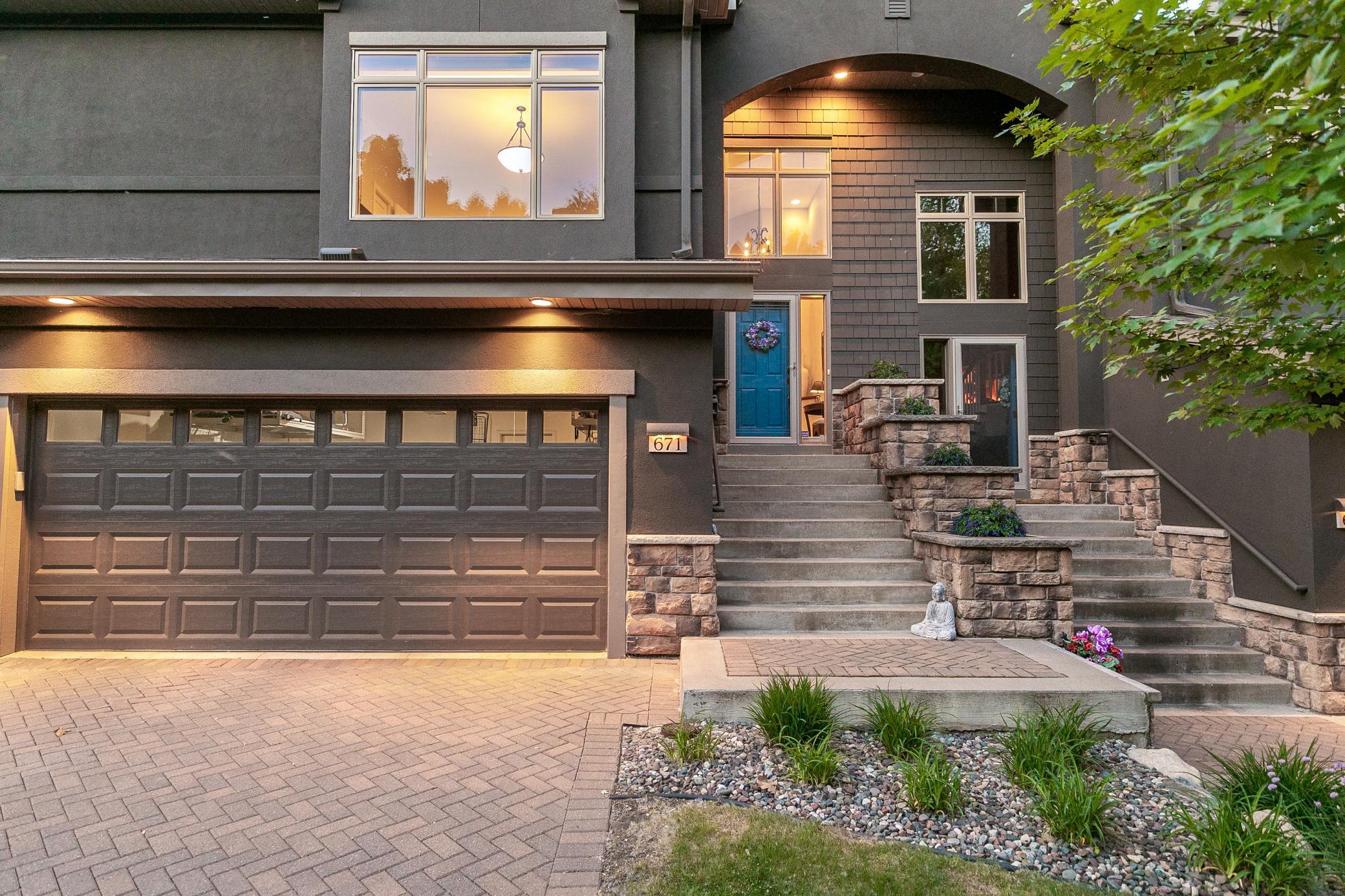 Upscale end unit with main-floor living, a private elevator, walkable to shopping and restaurants
