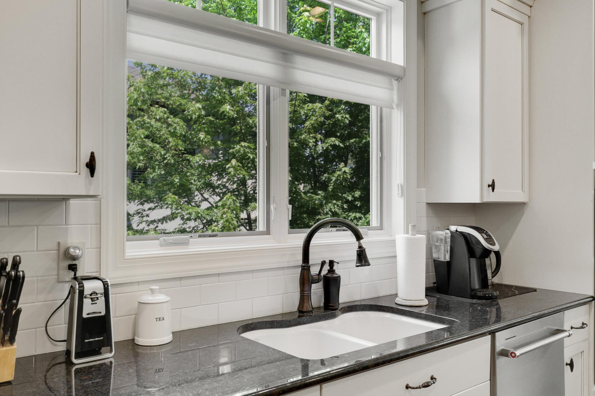 Upscale end unit with main-floor living, a private elevator, walkable to shopping and restaurants