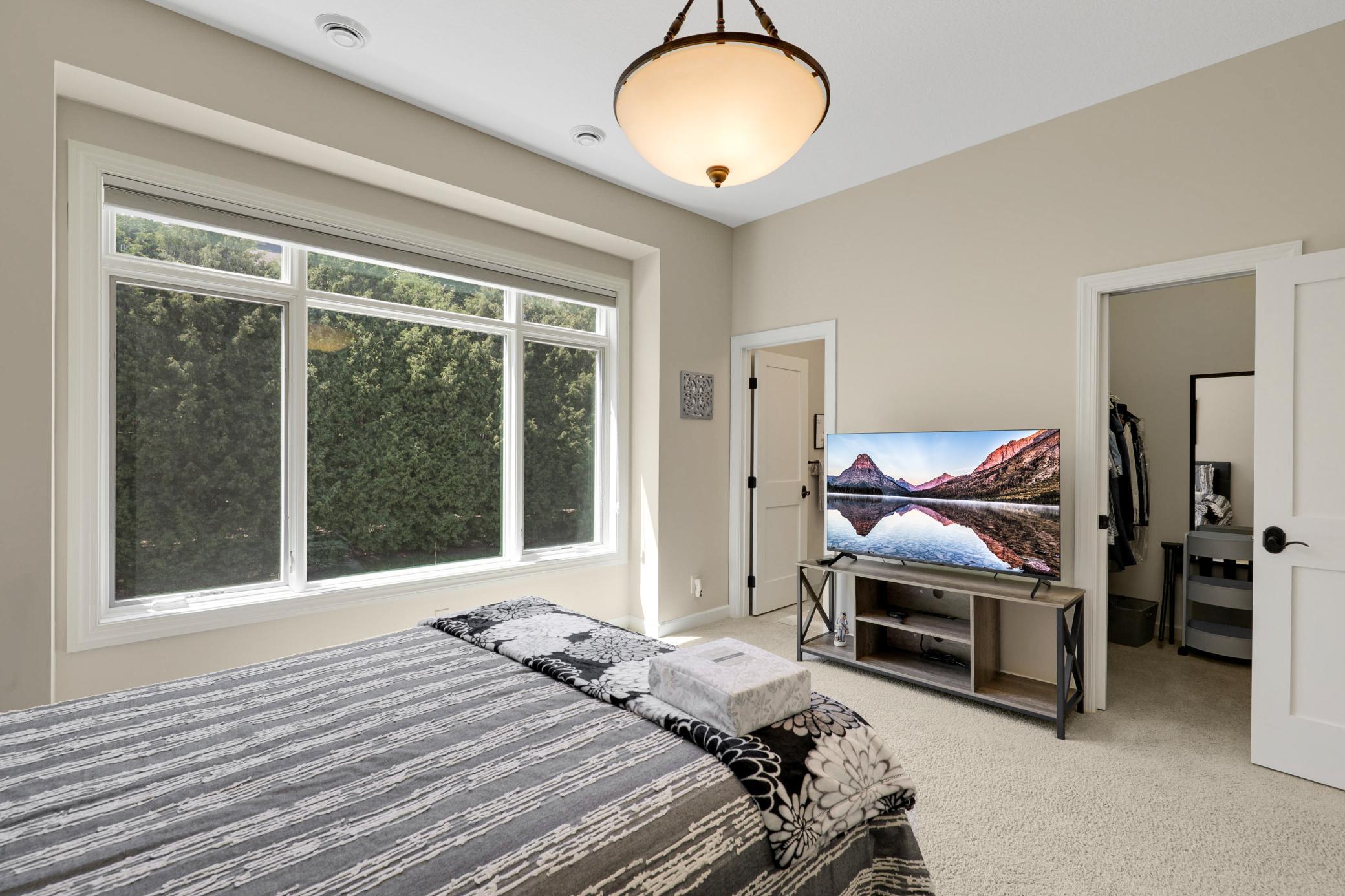 Upscale end unit with main-floor living, a private elevator, walkable to shopping and restaurants