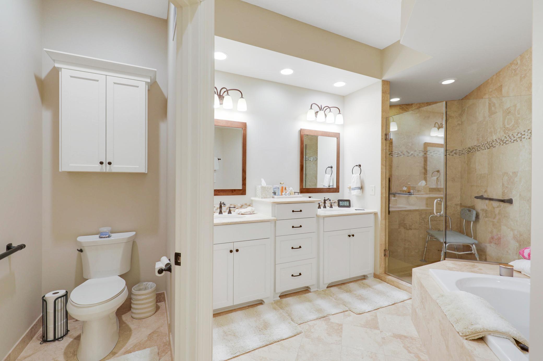 Upscale end unit with main-floor living, a private elevator, walkable to shopping and restaurants