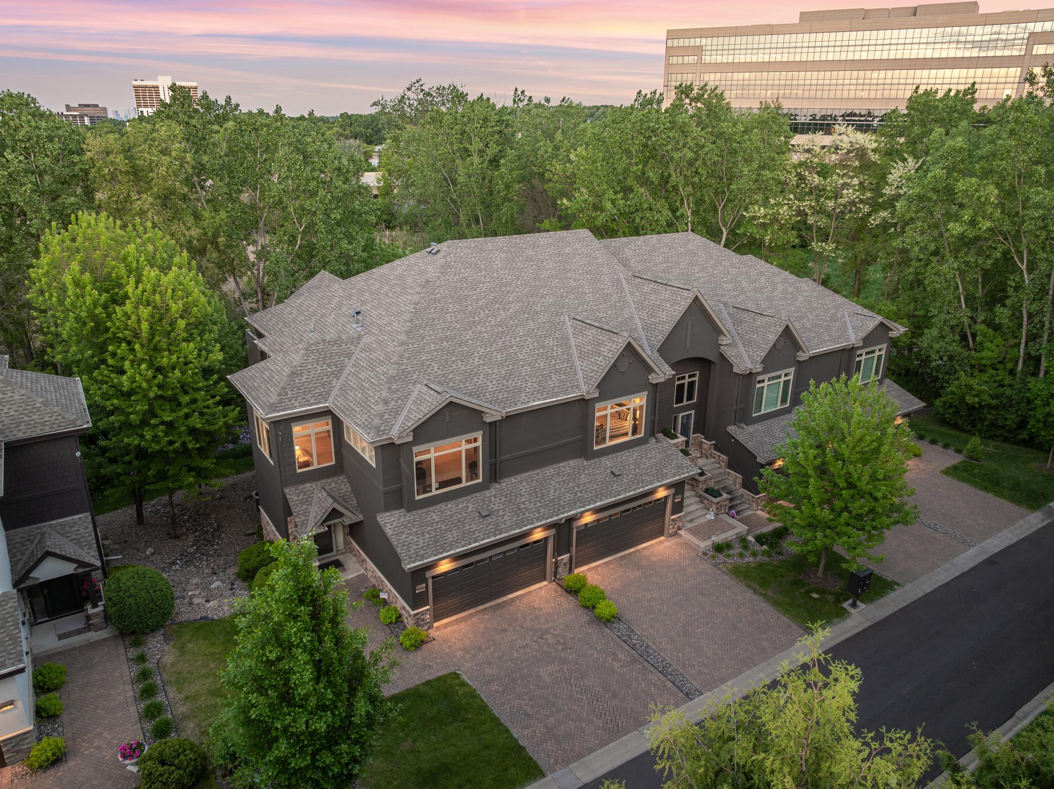Upscale end unit with main-floor living, a private elevator, walkable to shopping and restaurants