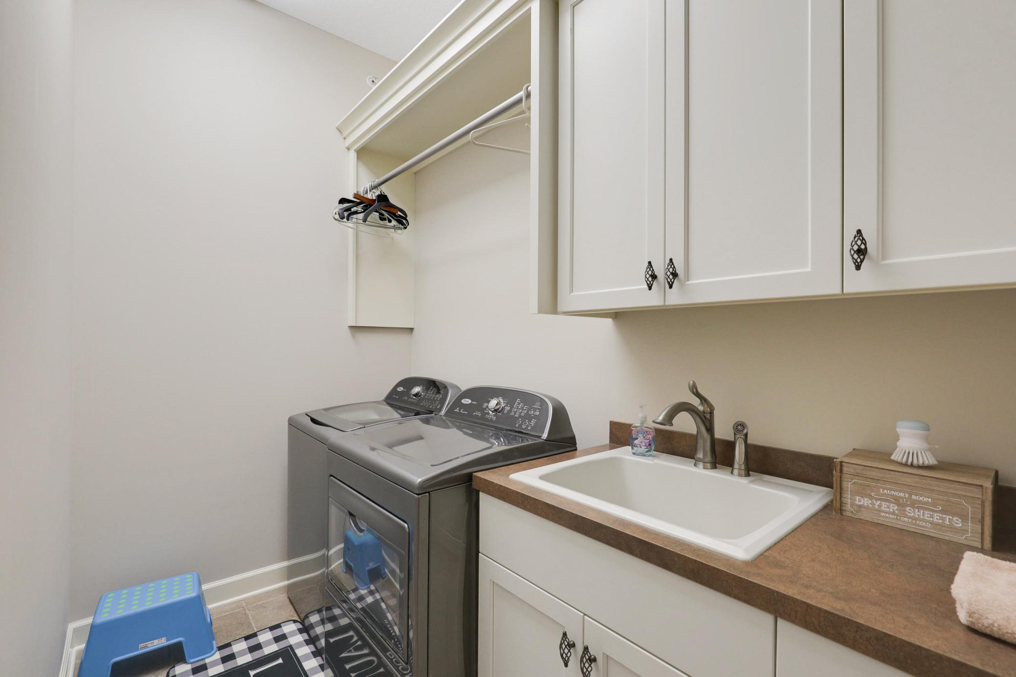 Upscale end unit with main-floor living, a private elevator, walkable to shopping and restaurants