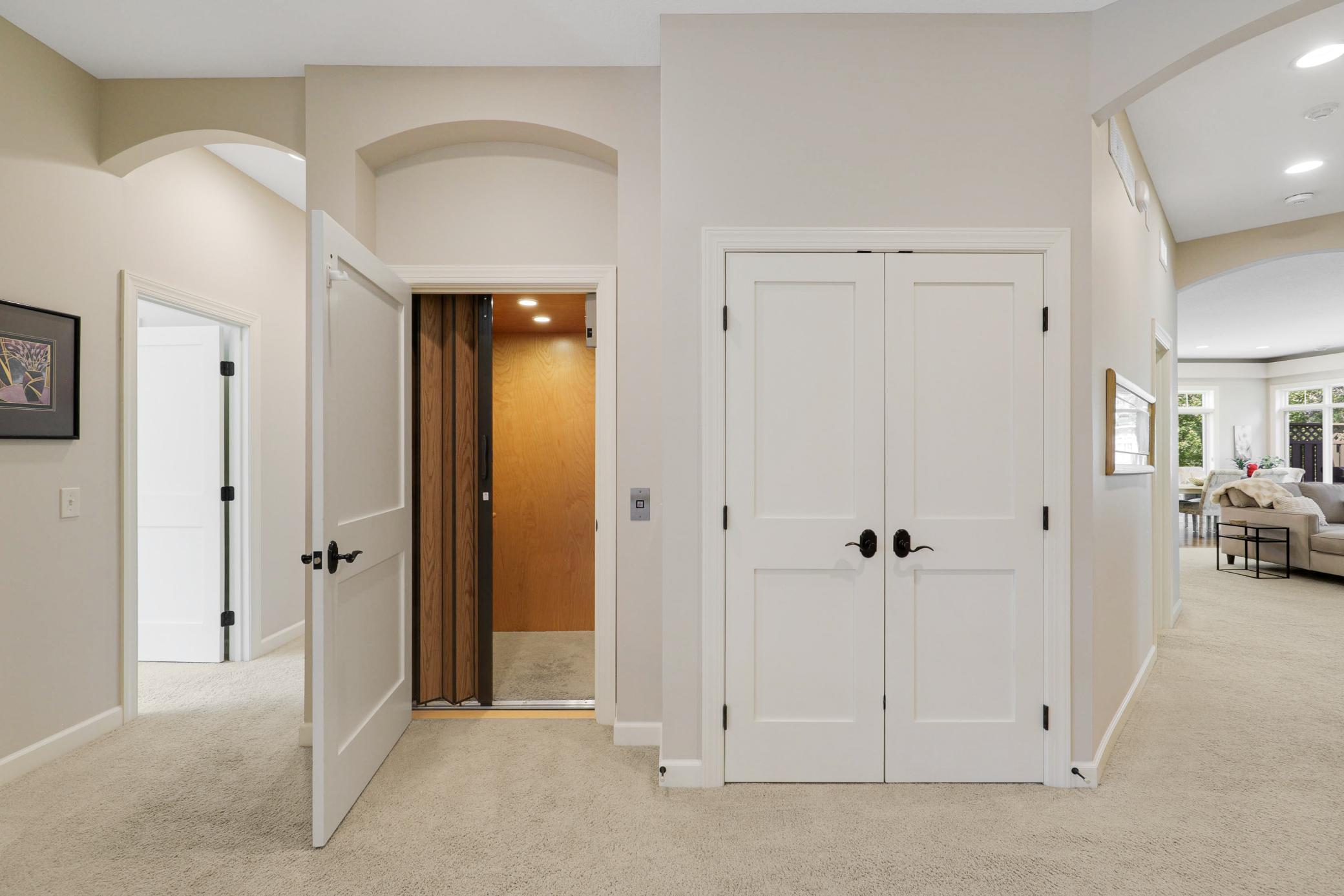 Upscale end unit with main-floor living, a private elevator, walkable to shopping and restaurants