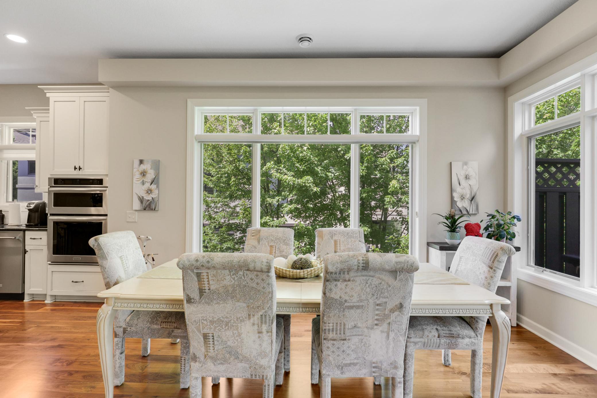 Upscale end unit with main-floor living, a private elevator, walkable to shopping and restaurants