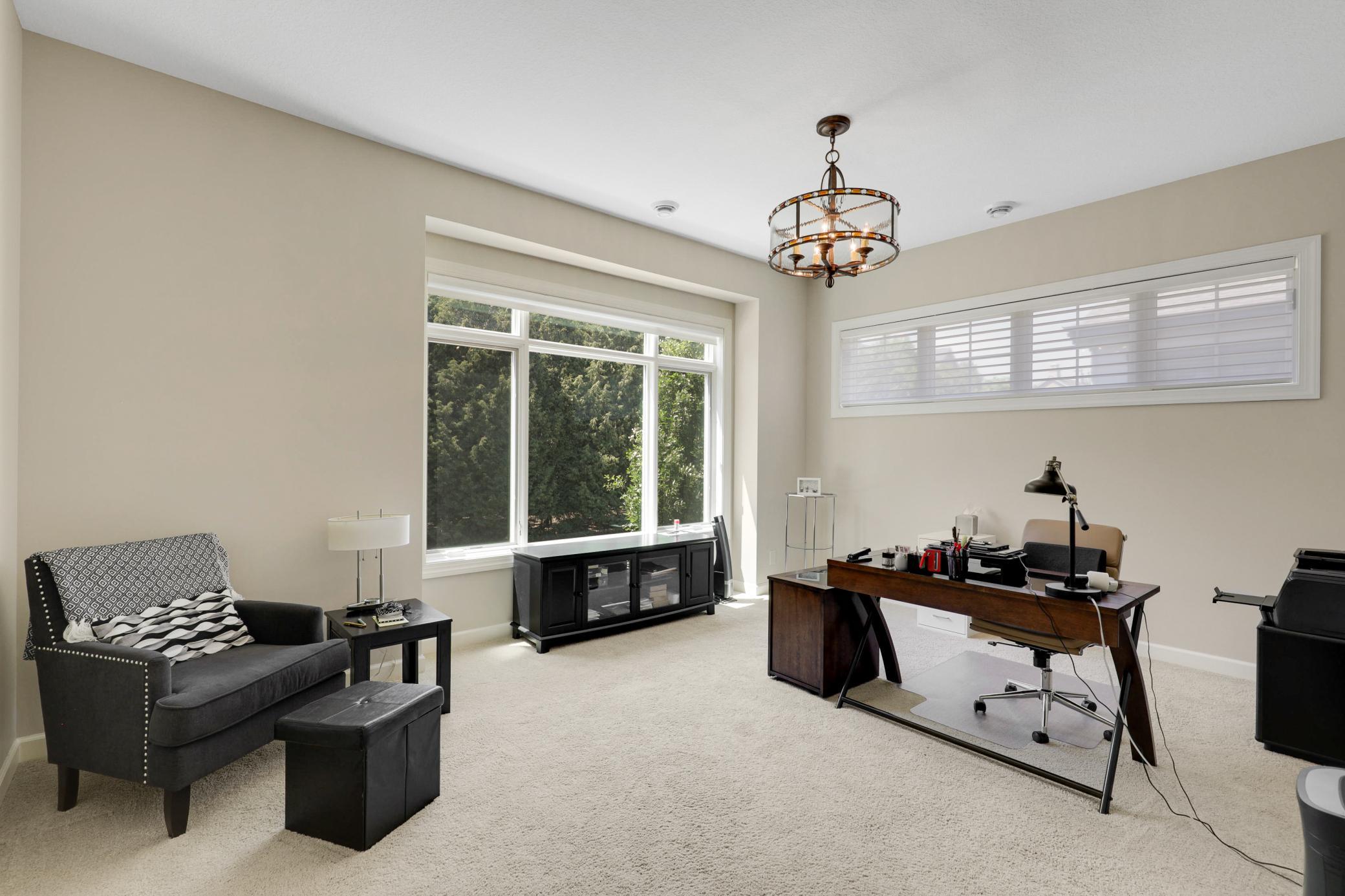 Upscale end unit with main-floor living, a private elevator, walkable to shopping and restaurants