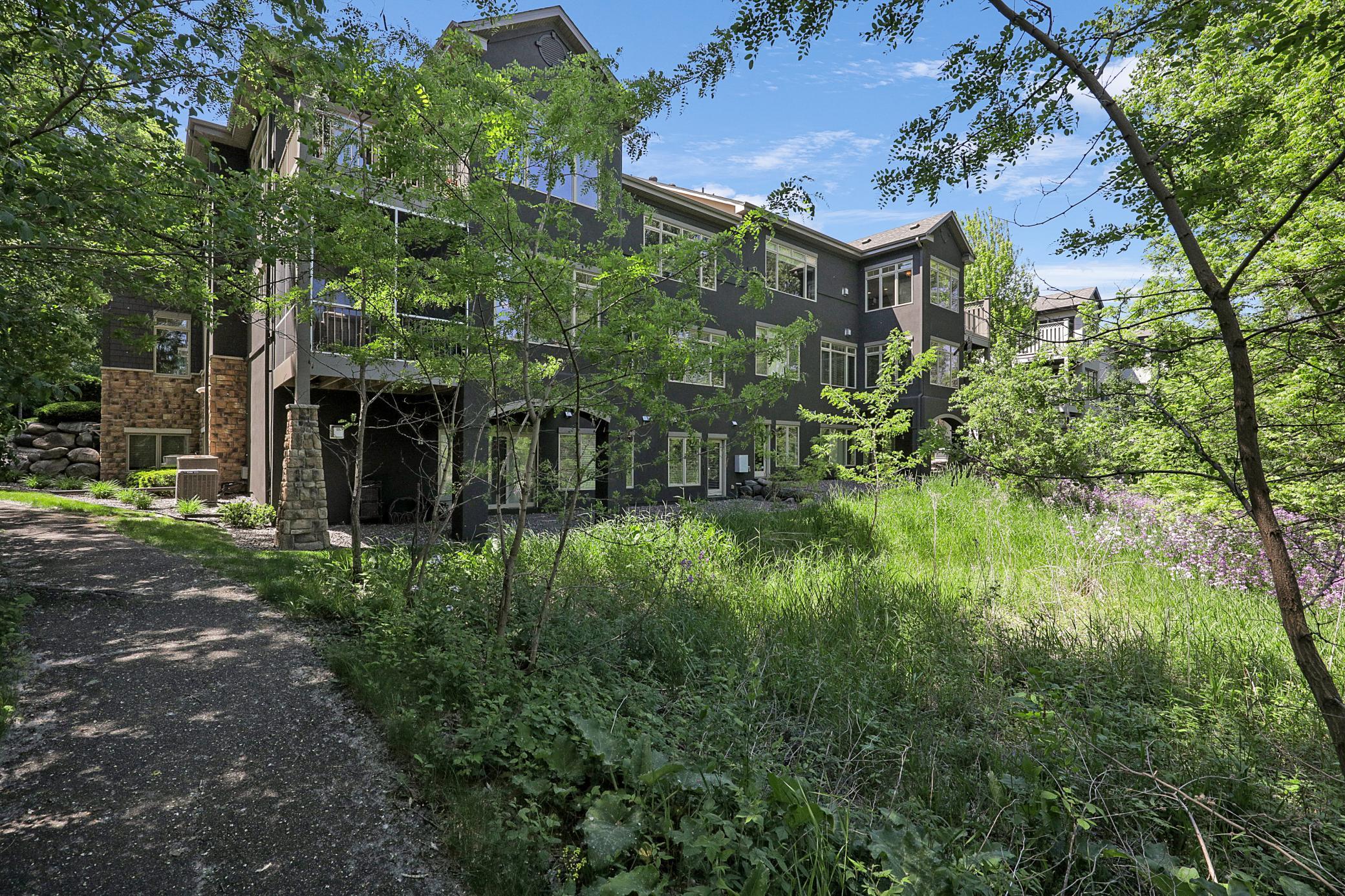 Upscale end unit with main-floor living, a private elevator, walkable to shopping and restaurants