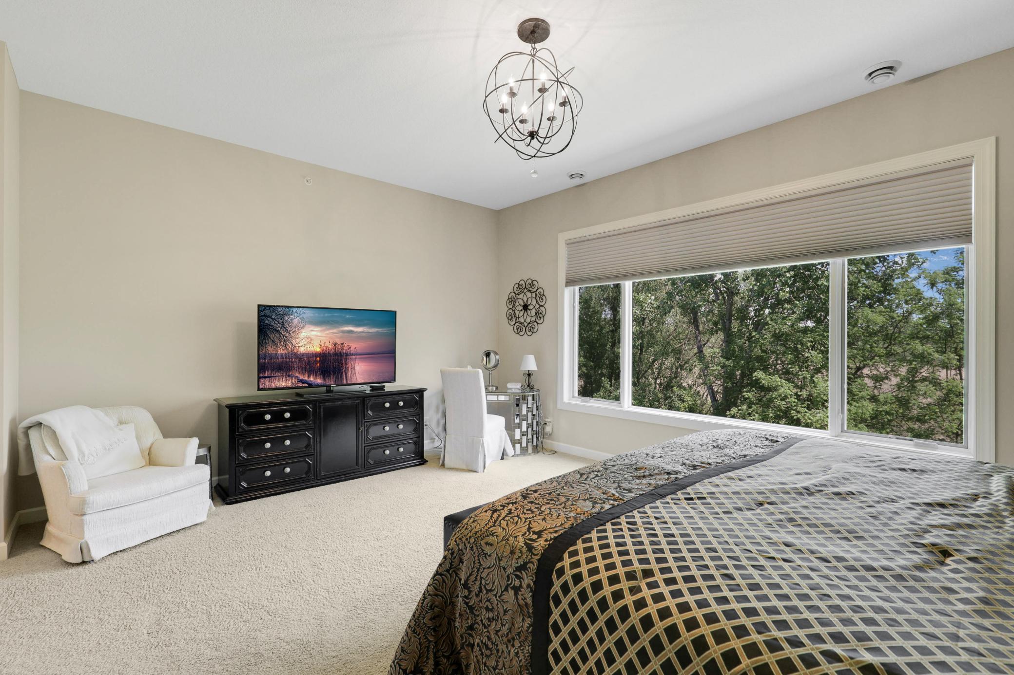 Upscale end unit with main-floor living, a private elevator, walkable to shopping and restaurants
