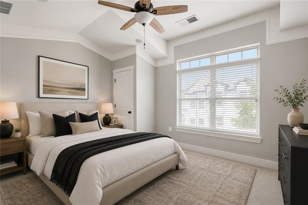Staged bedroom with a queen bed, dark throw, ceiling fan, and large window with blinds.