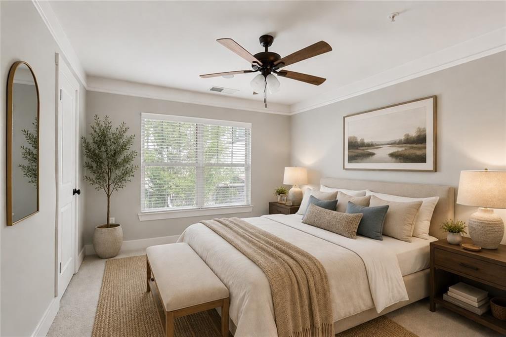Bedroom with neutral bedding, a ceiling fan, and a wide window with white blinds.