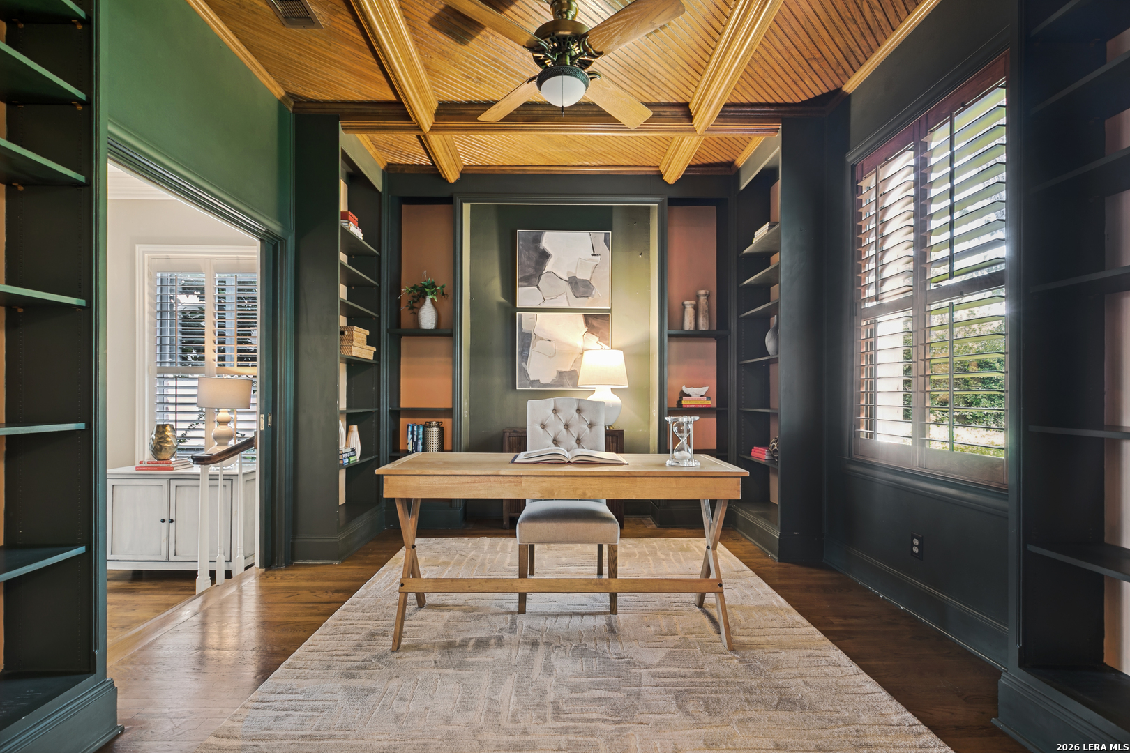 Dedicated study in a Terrell Hills home featuring custom built-ins, a wood-paneled ceiling, and natural light.