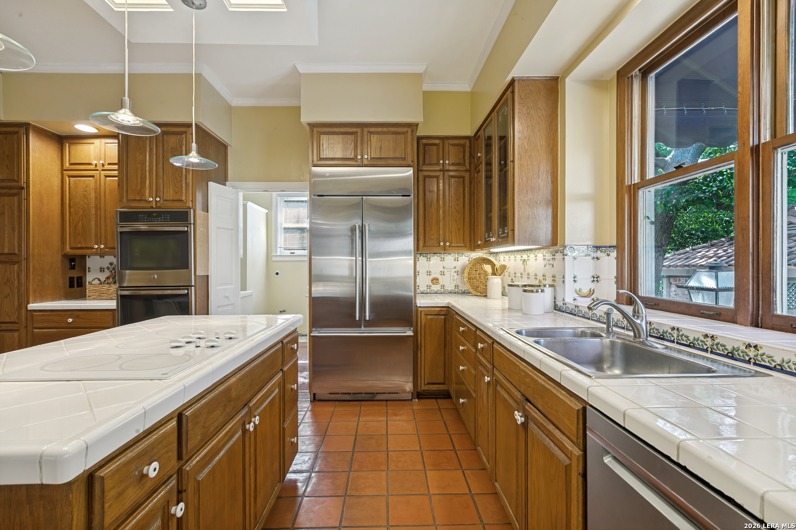 Kitchen in a Terrell Hills home featuring a center island, double ovens, and stainless steel appliances.