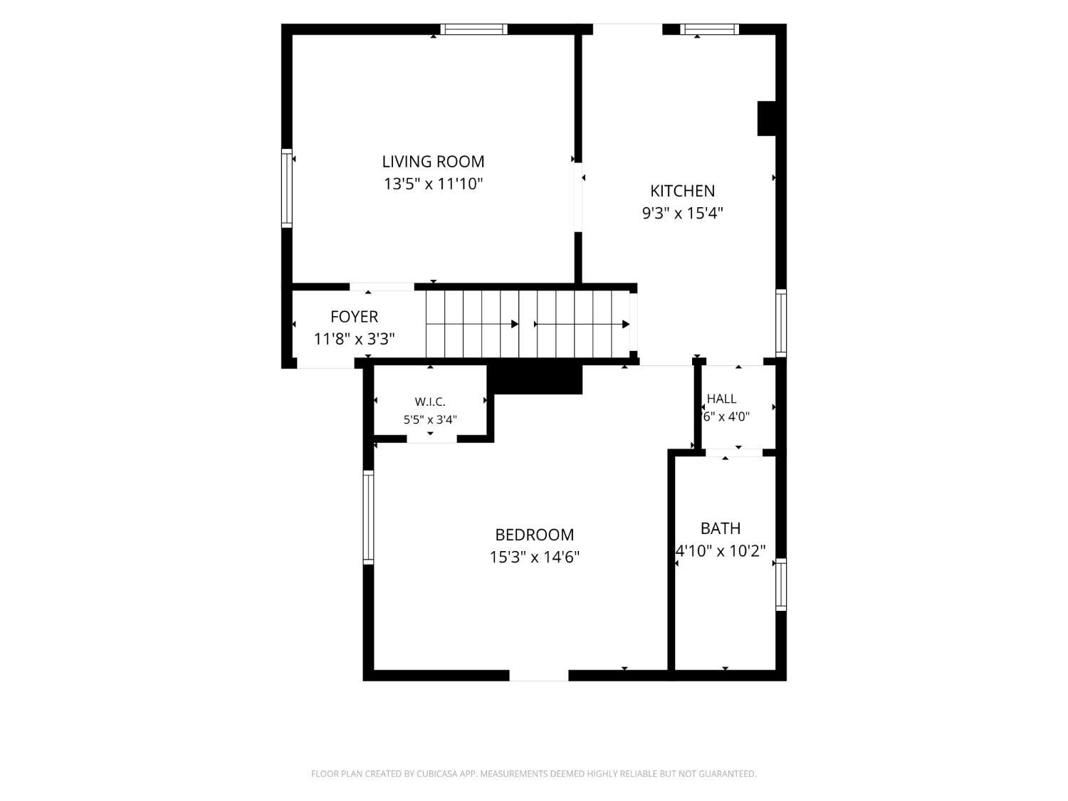 Floor plan showing a living room, kitchen, foyer, bedroom, walk-in closet, hall, bath, and stairs.