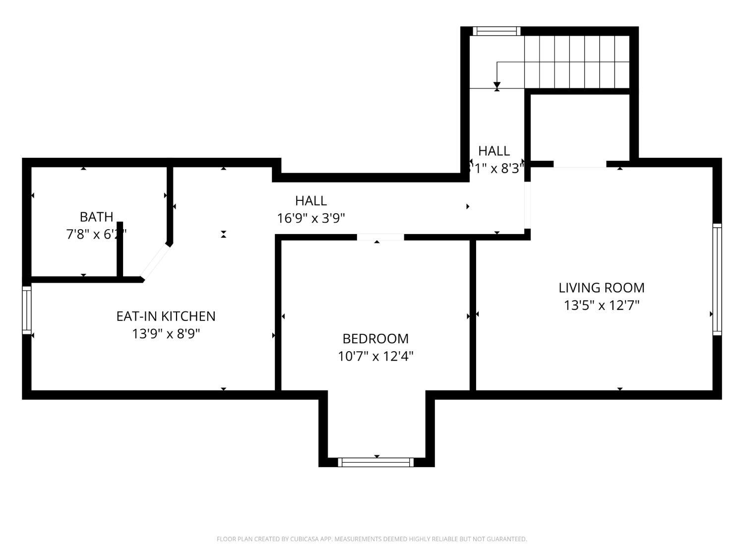 Floor plan showing a bath, eat-in kitchen, bedroom, living room, halls, and staircase.