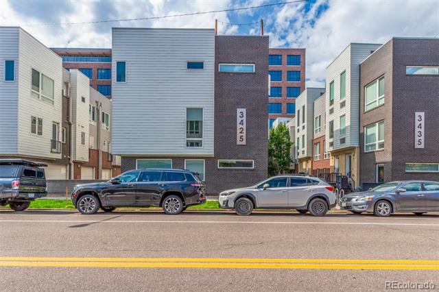 Modern multi-unit residences at 3425 Larimer Street, with parked cars along the street.