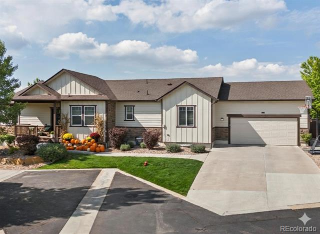 Single-story home with an attached garage and a pumpkin-decorated front porch.