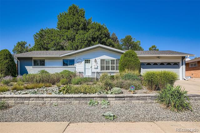Single-story ranch house with an attached garage and landscaped gravel yard.