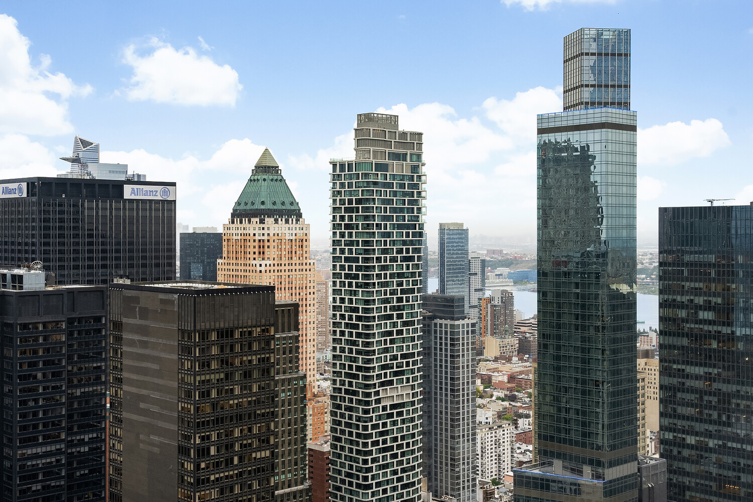 City skyline of high-rise buildings, with a river visible in the distance.