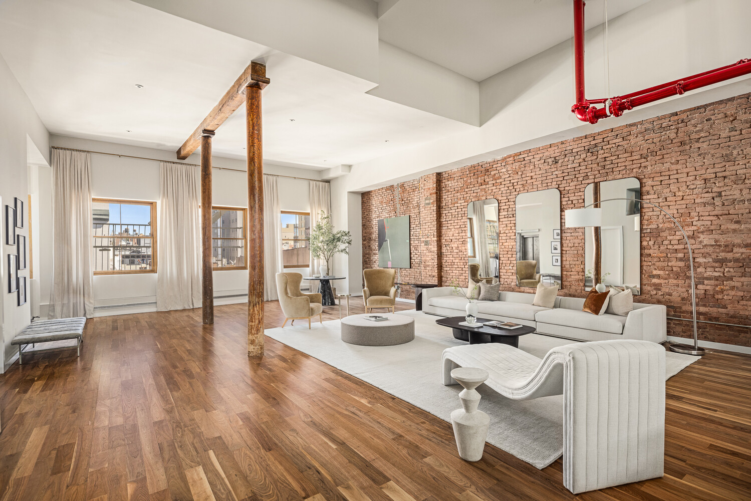 Loft living room with exposed brick walls, timber columns, and contemporary seating.