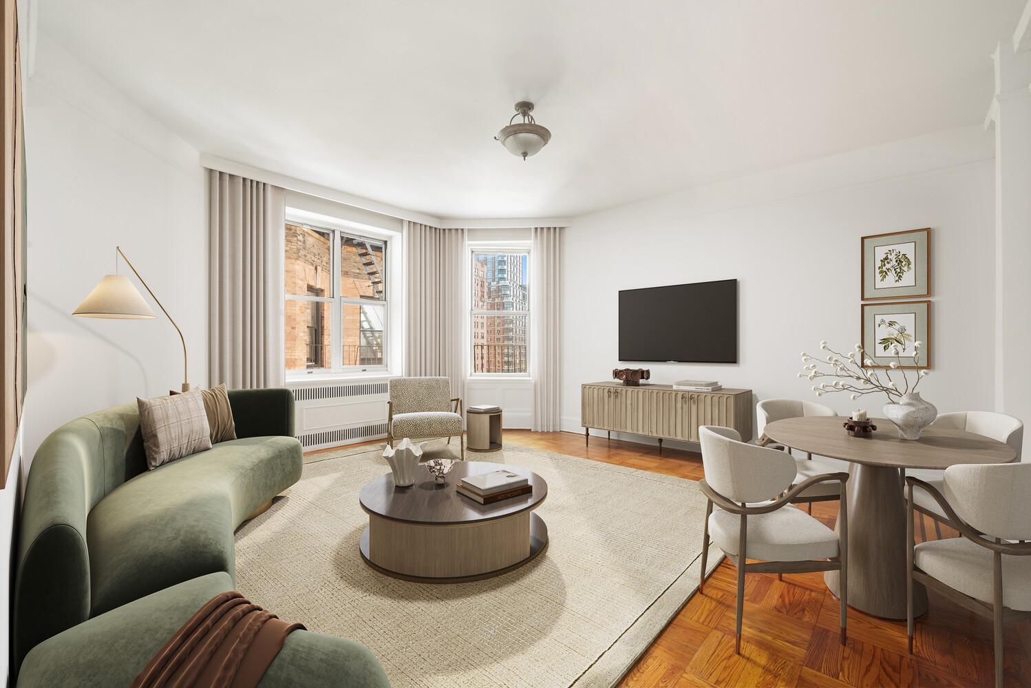 Furnished living room with a curved green sofa, dining area, and city buildings visible through the windows.