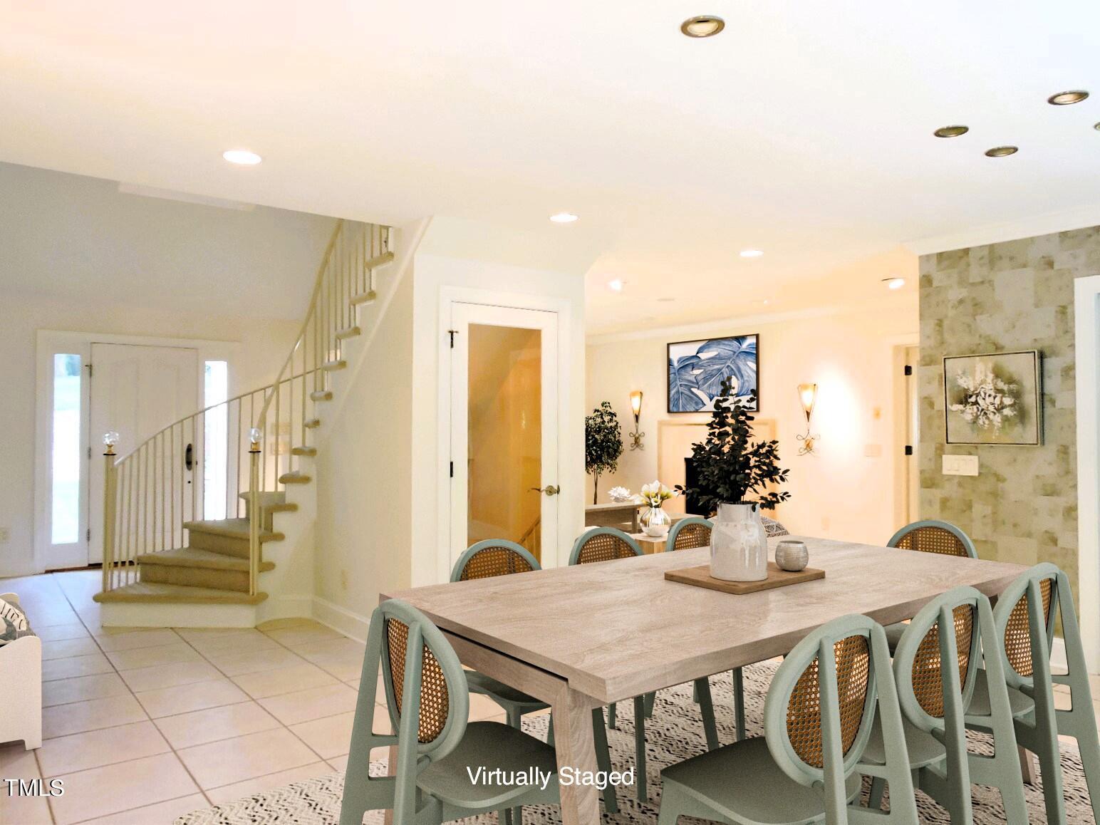 Virtually staged dining room with a long table beside a curved staircase and tiled entry.
