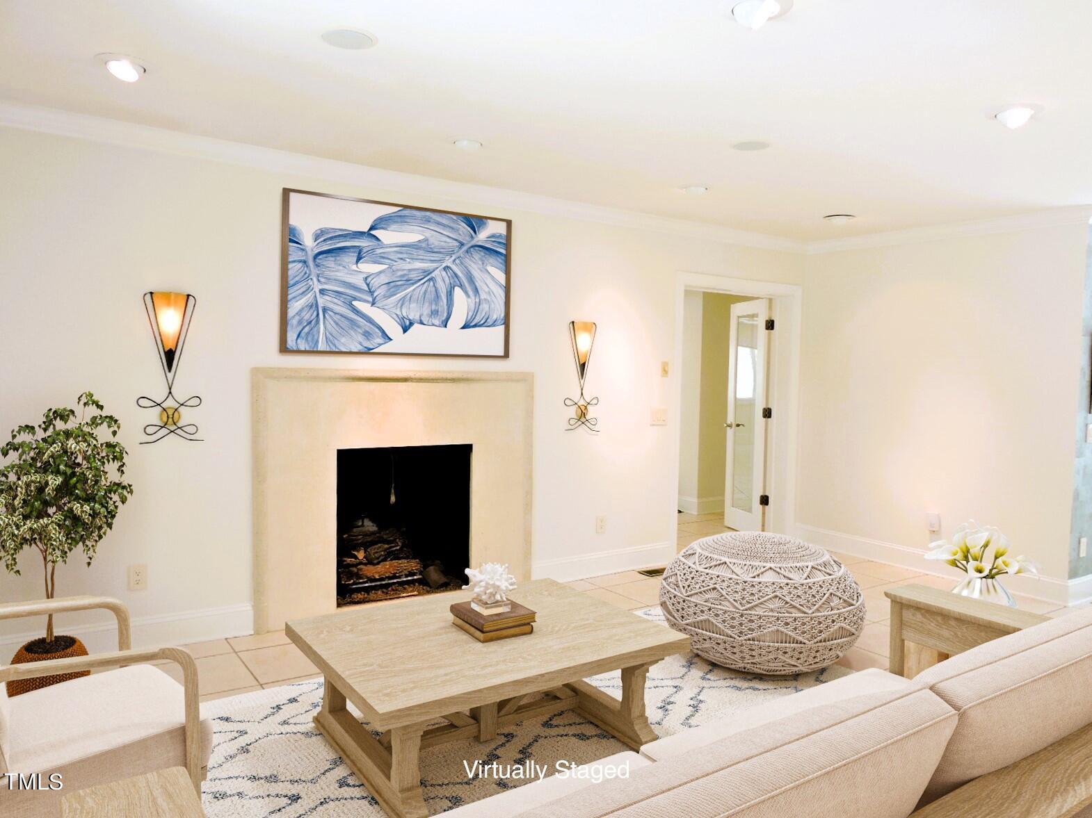 Living room with a stone fireplace, light furnishings, and blue-and-white artwork.