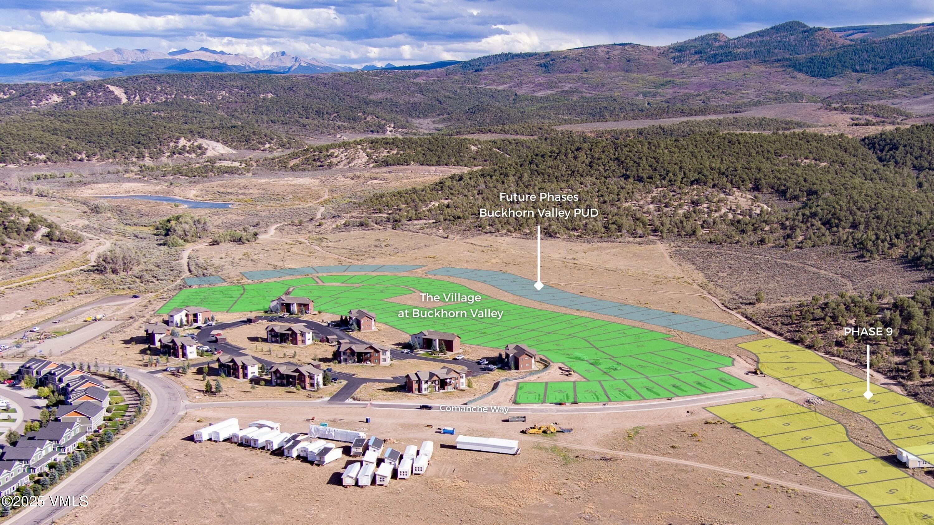Aerial view of Buckhorn Valley lots and homes, with colored phase overlays and mountains beyond.