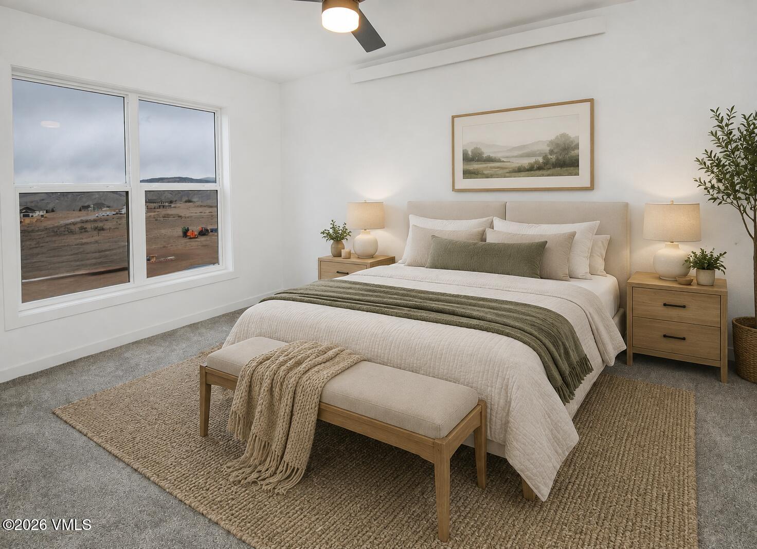 Staged bedroom with a white bed, sage-green throw, wood nightstands, and a large window.