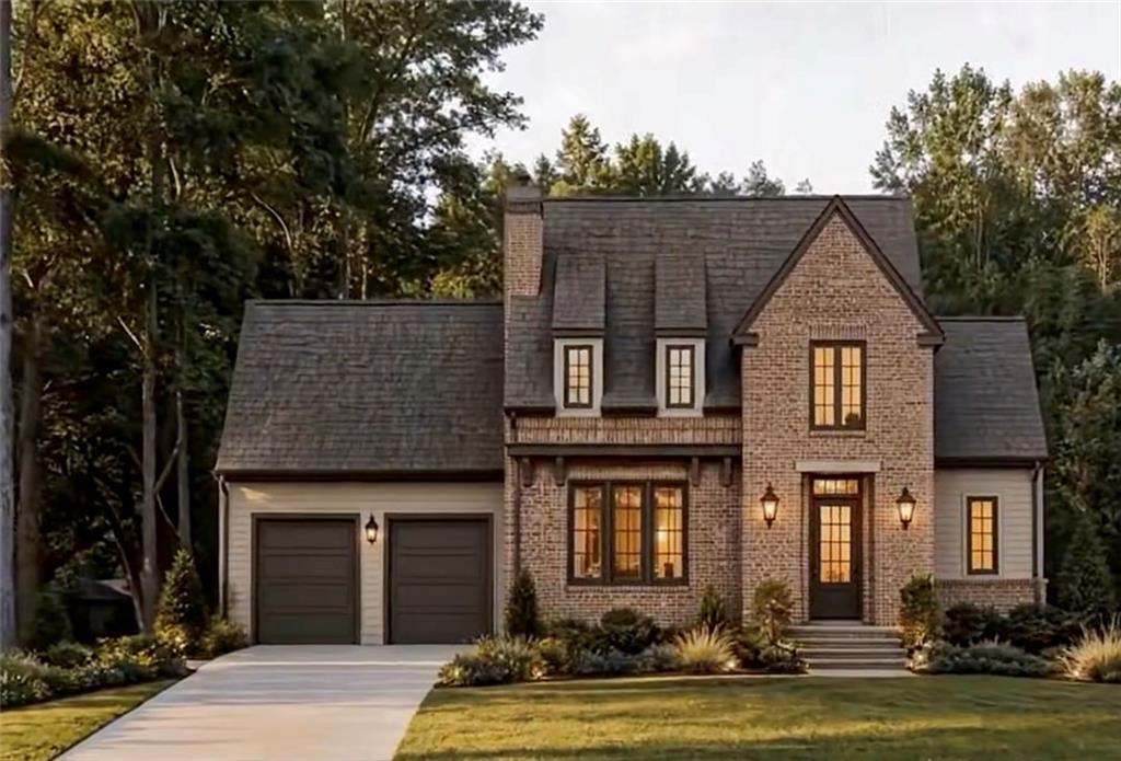 Brick-and-siding two-story house with a steep roof, double garage, and landscaped front lawn.