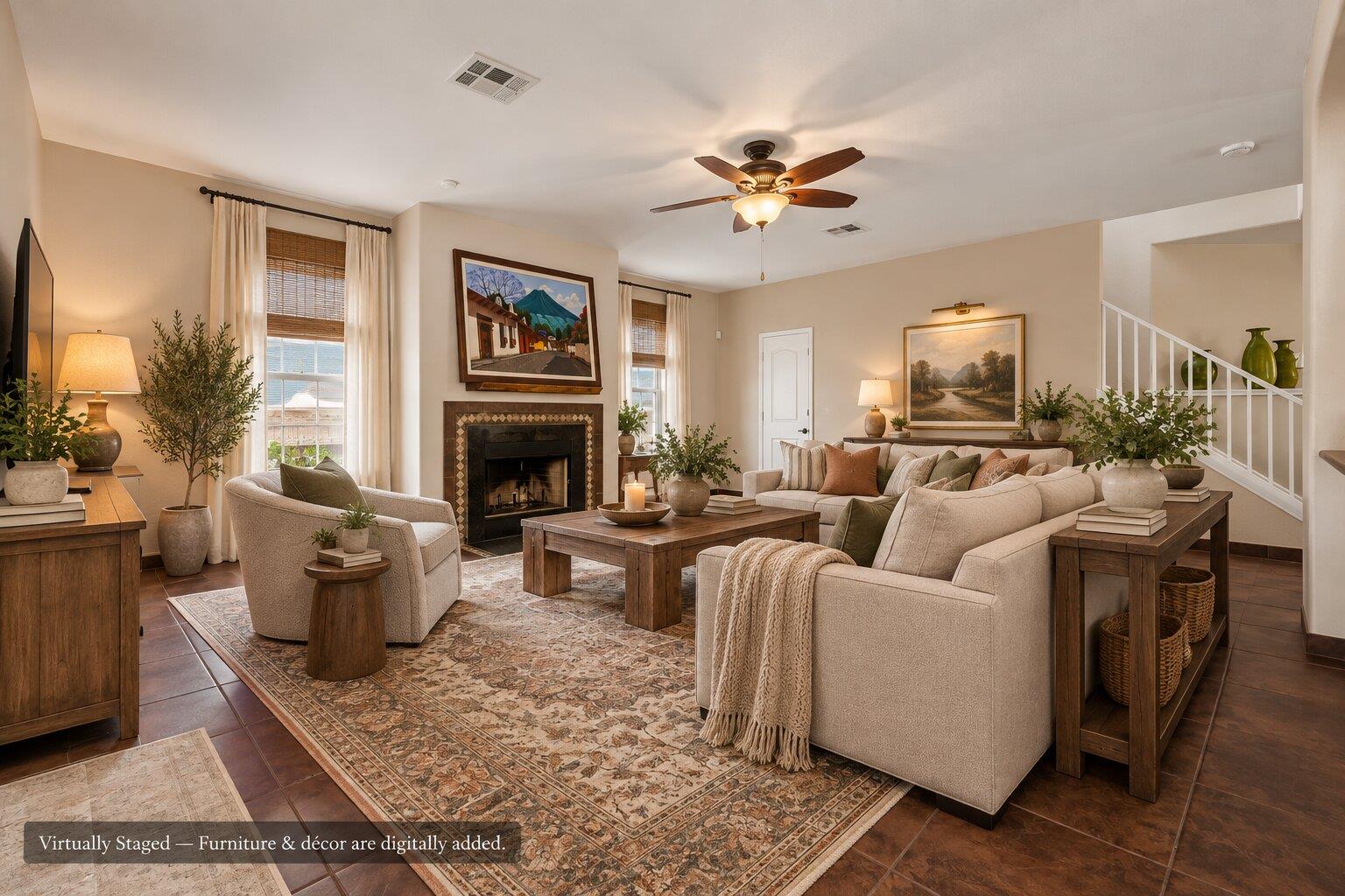Virtually staged living room with cream seating, a tiled fireplace, patterned rugs, and a staircase.