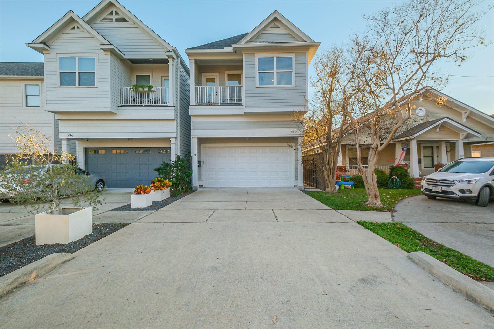Two-story gray home with a covered balcony and white garage door marked 508.
